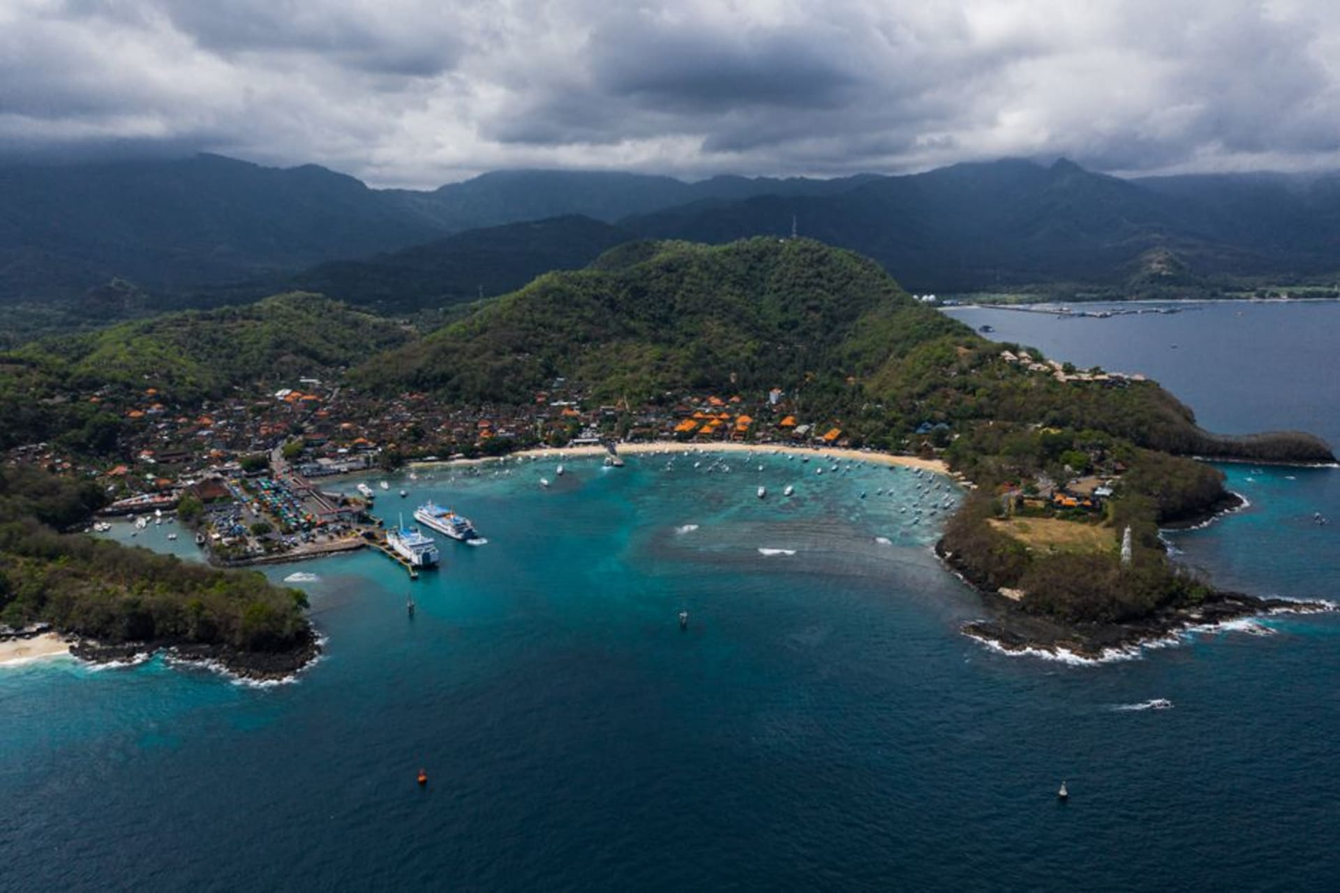 Fishing boats and ferries anchored in Padang Bai harbor, East Bali