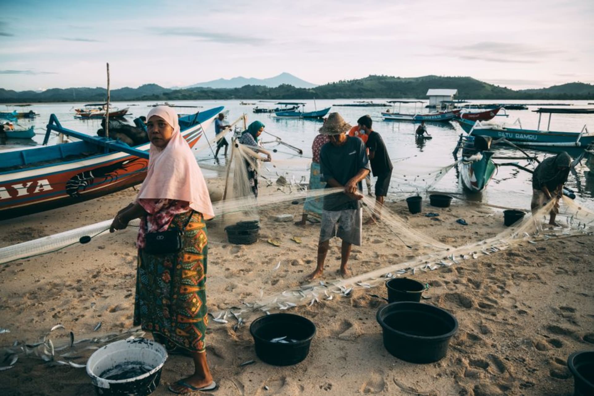 Padang's waterfront at sunset with fishing boats and the Indian Ocean coastline