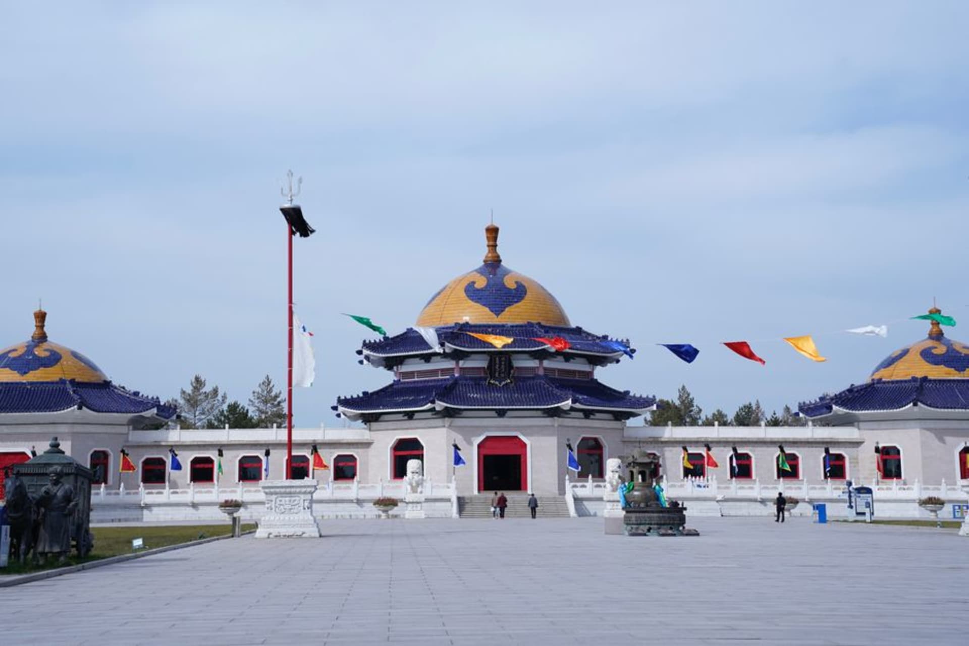 White-domed Mongol-style mausoleum complex under a wide steppe sky near Ejin Horo Banner