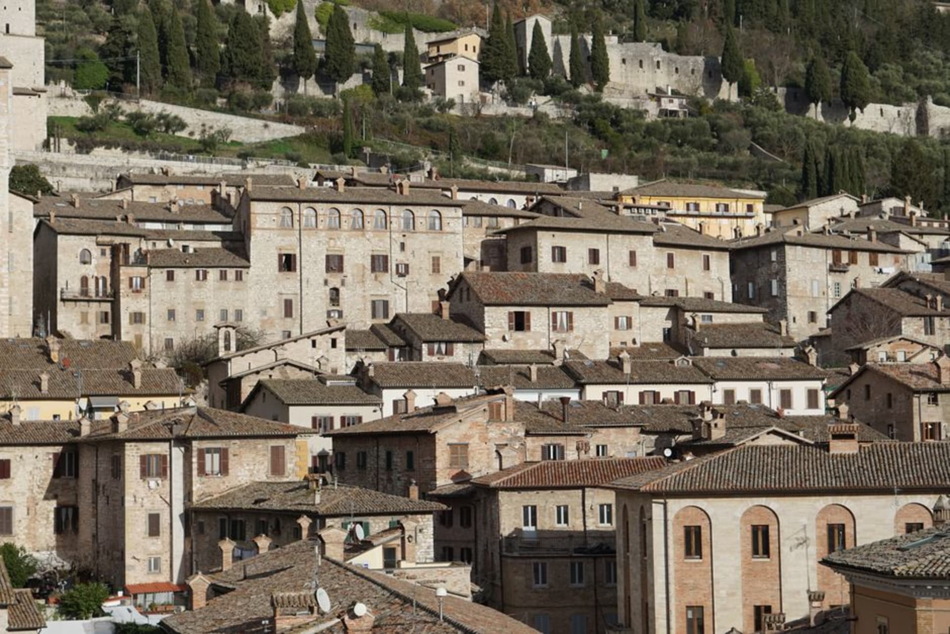 Gubbio's stacked medieval stone buildings rising up the slope of Monte Ingino