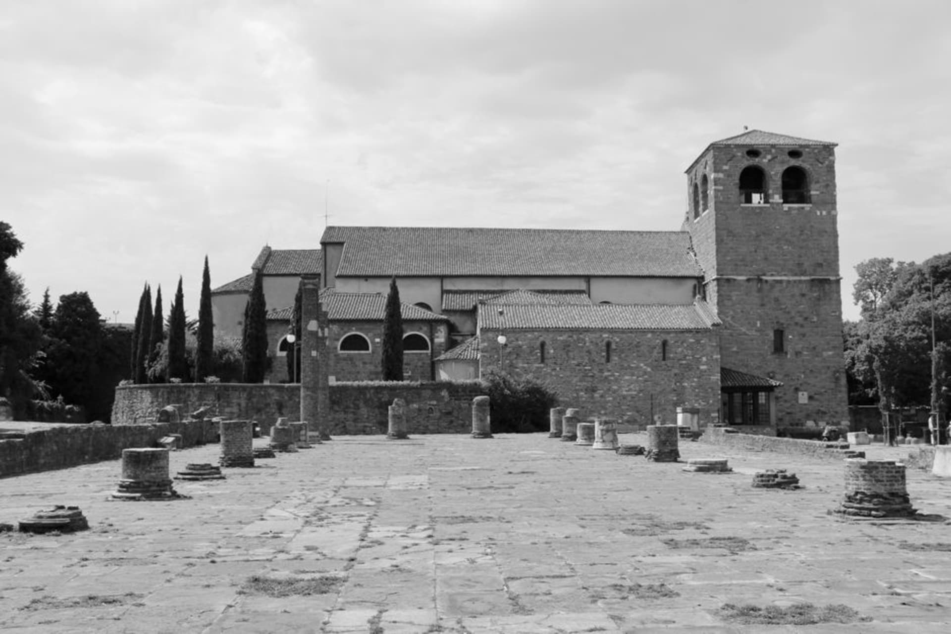 The tall bell tower of Aquileia's basilica rising over the flat Friulian countryside