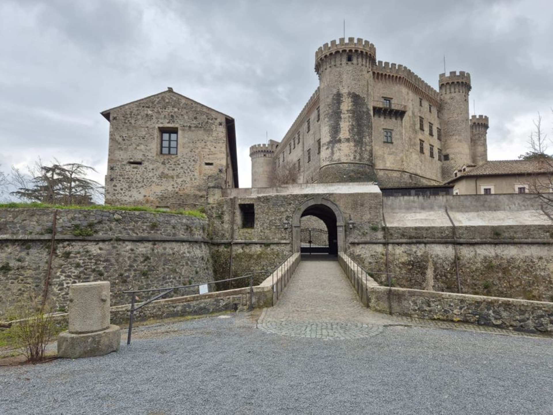 Castello Orsini-Odescalchi's fortified towers overlooking Lake Bracciano at dusk