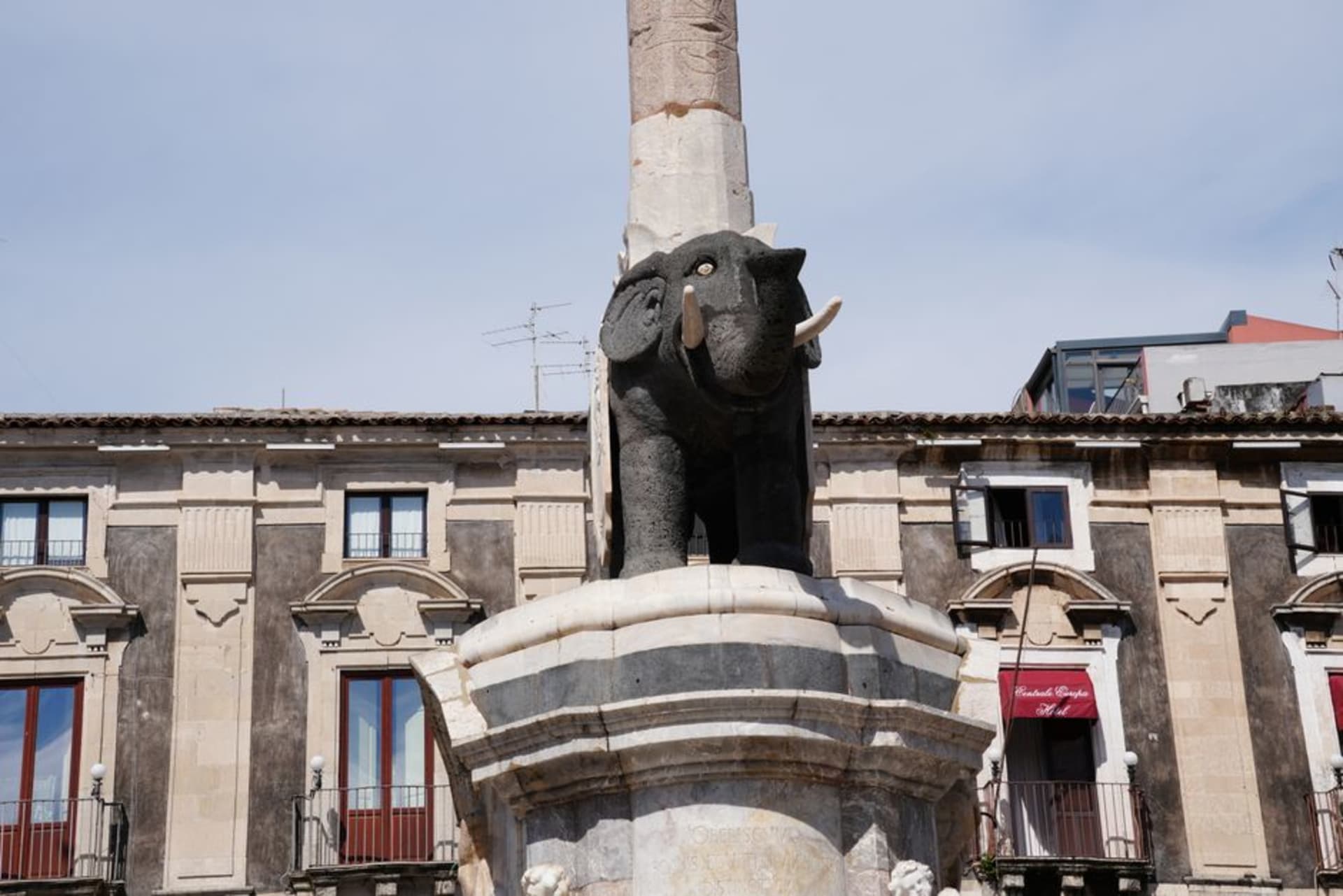 Catania's black lava-stone Baroque cathedral square with Mount Etna visible behind