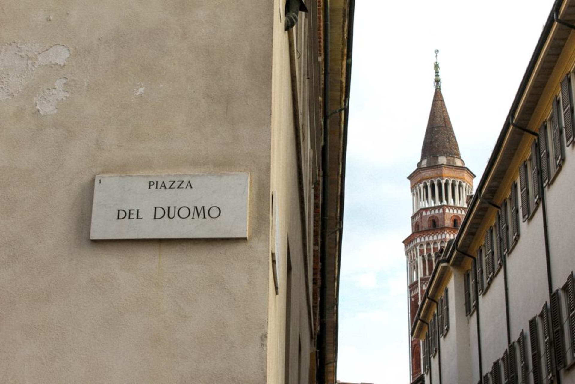 Cremona's Romanesque cathedral and the Torrazzo bell tower rising above the piazza