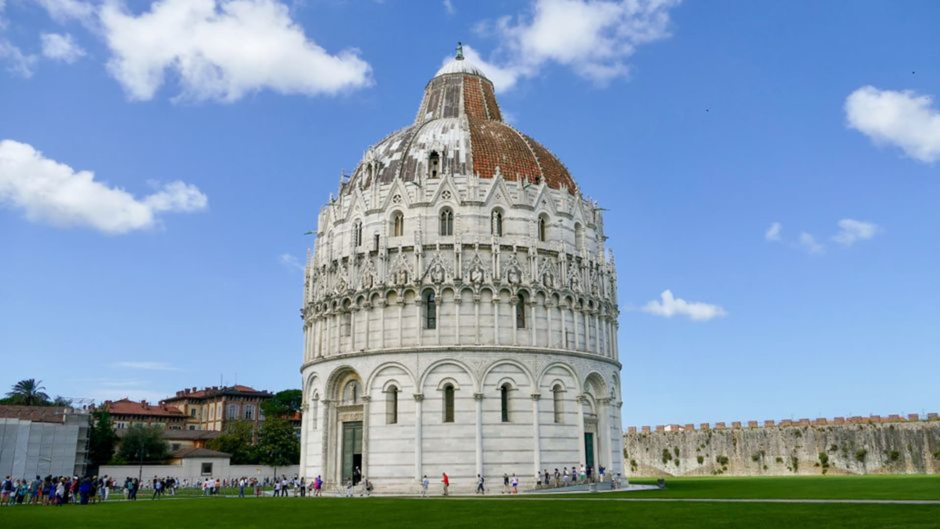 Parma's pink-and-white marble Baptistery beside the Duomo under a soft afternoon sky