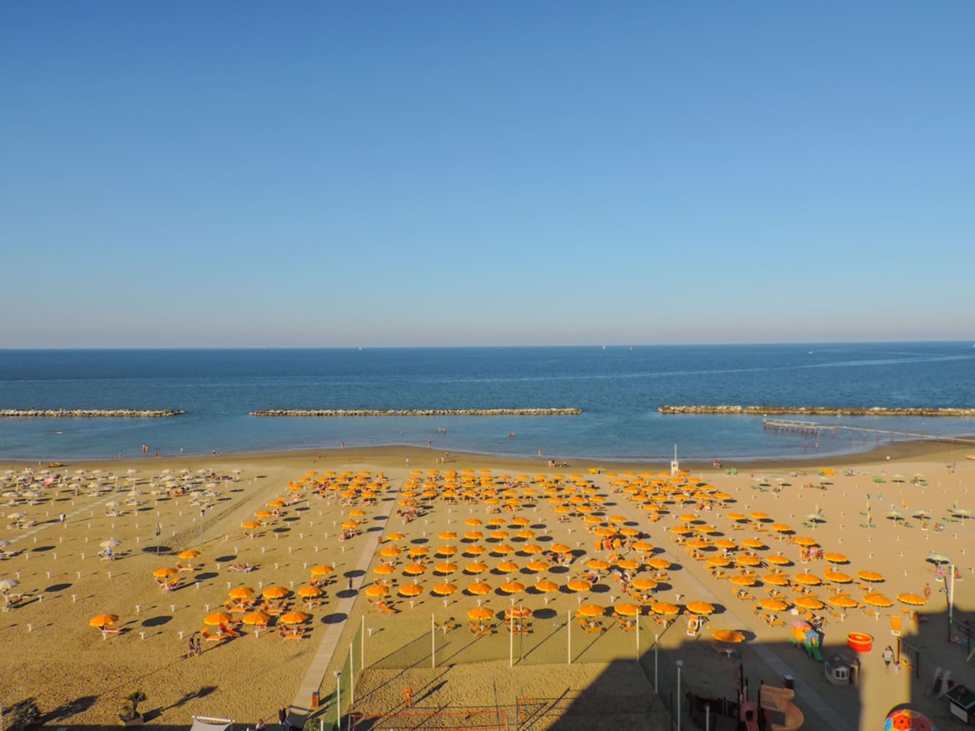 Rimini's long sandy Adriatic beach lined with rows of colorful umbrellas