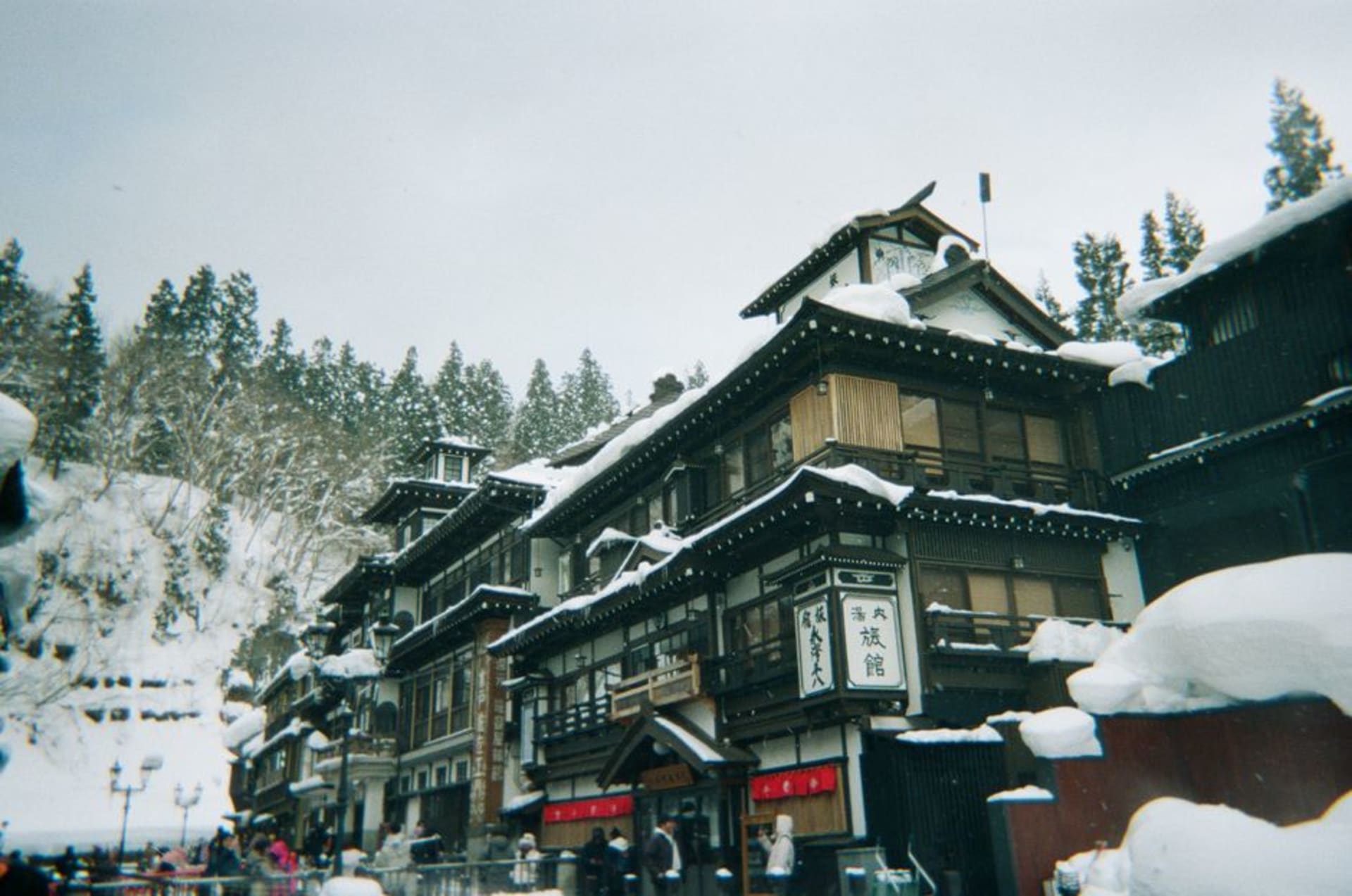 Wooden bathhouse and temple rooftops in the hill valley of Bessho Onsen, Nagano