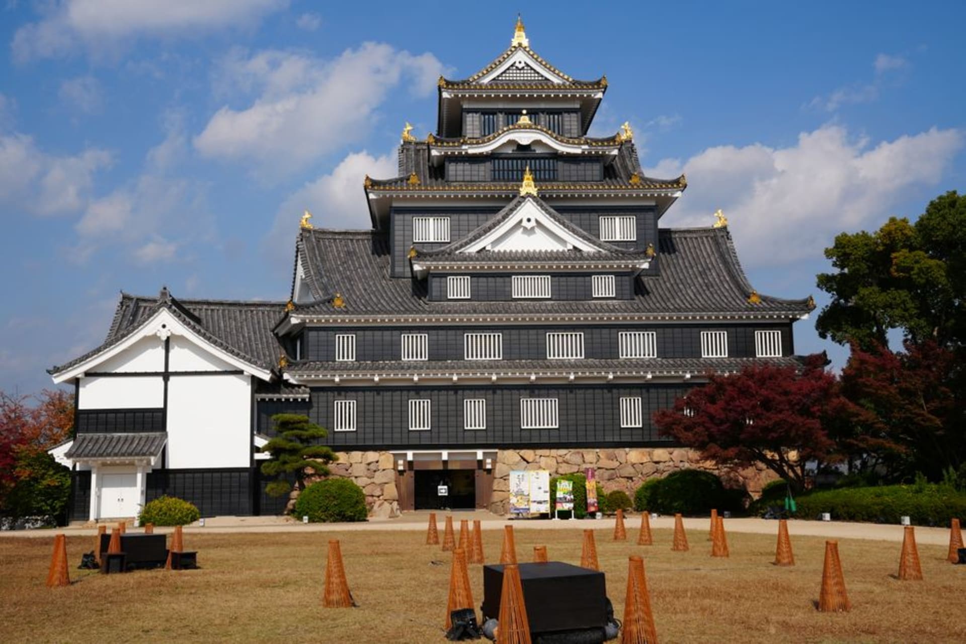 Kishiwada Castle's white keep rising above stone walls against the Osaka-bay sky