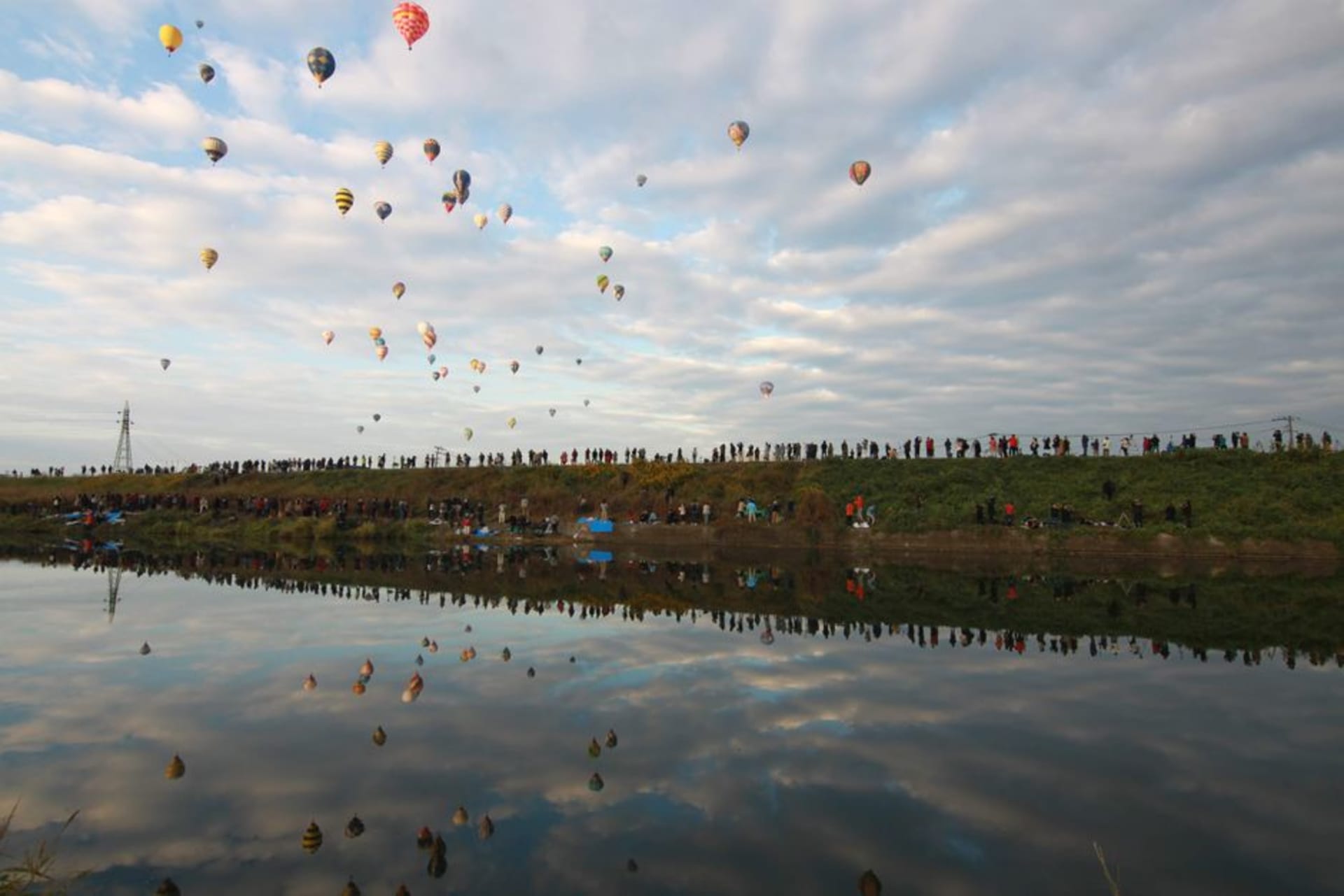 Hot-air balloons rising over the Kase River during the Saga balloon fiesta