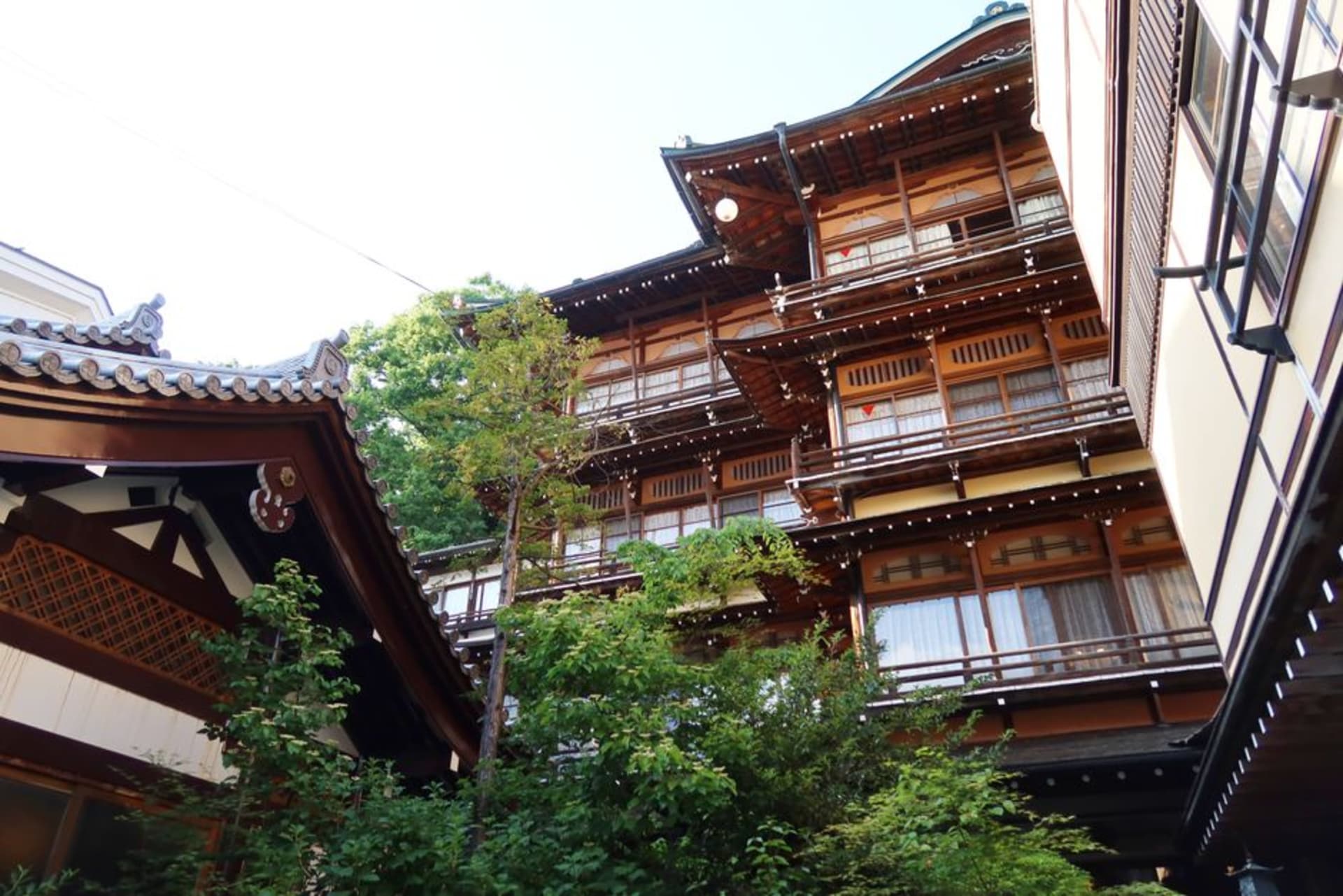 The narrow cobbled lane of wooden inns at Shibu Onsen with steam rising