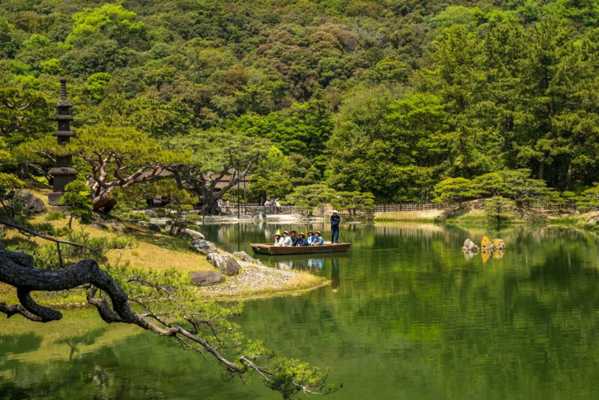 Ritsurin Garden's ponds and clipped pines with Mount Shiun rising behind