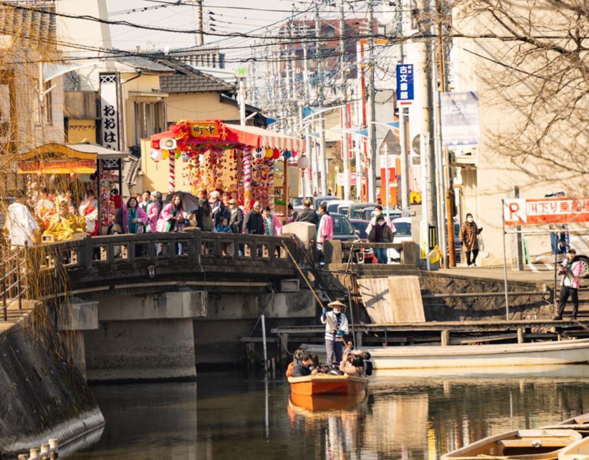 A donkobune punt gliding down a willow-lined canal in Yanagawa