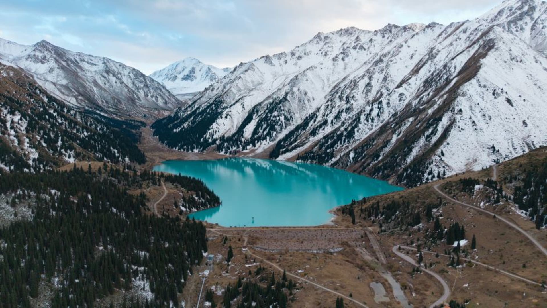 Aguas turquesa del lago Big Almaty rodeadas por las montañas Trans-Ili Alatau