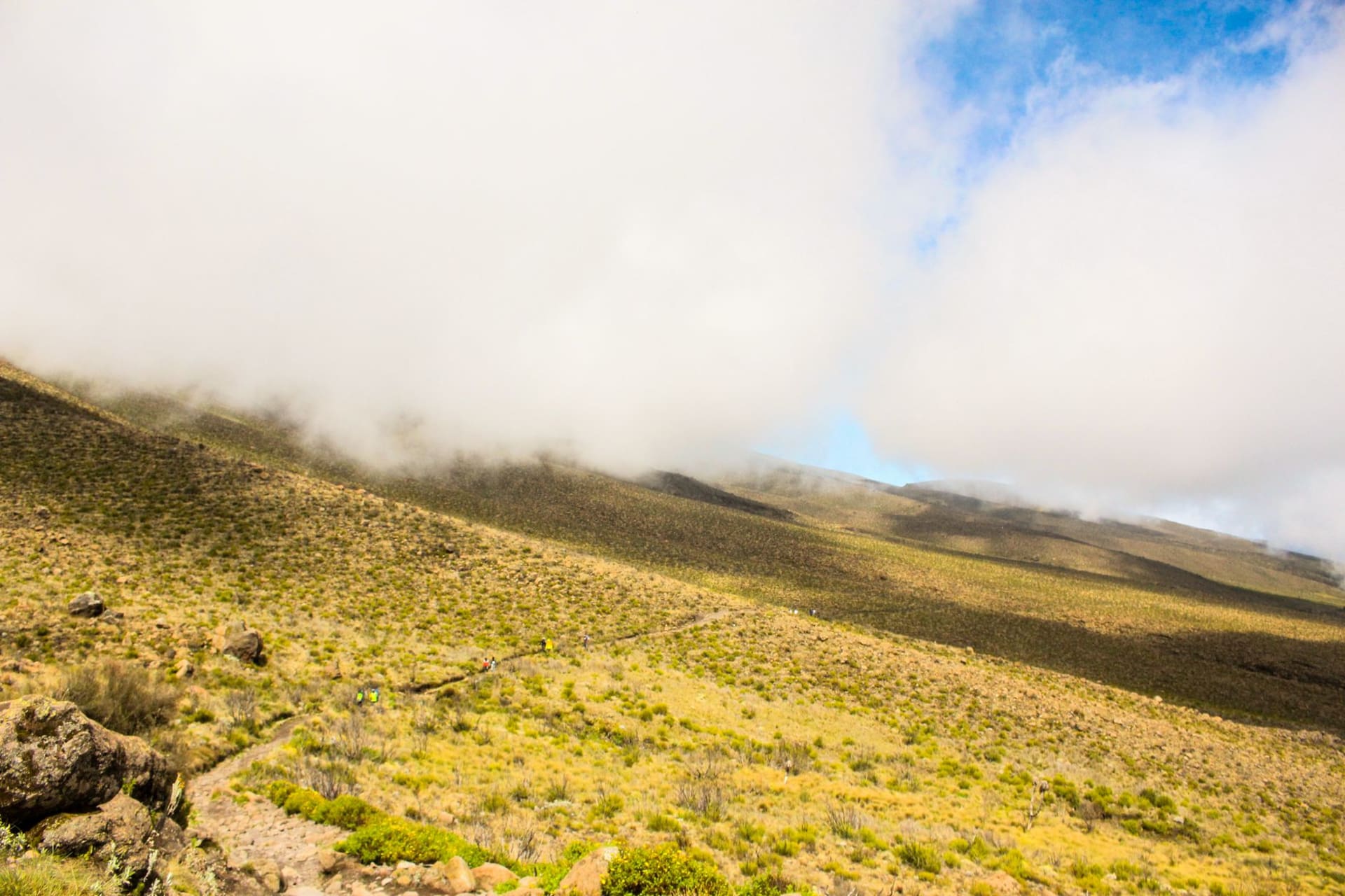 The town of Same with the Pare Mountains rising dramatically behind it under a wide African sky with scattered clouds