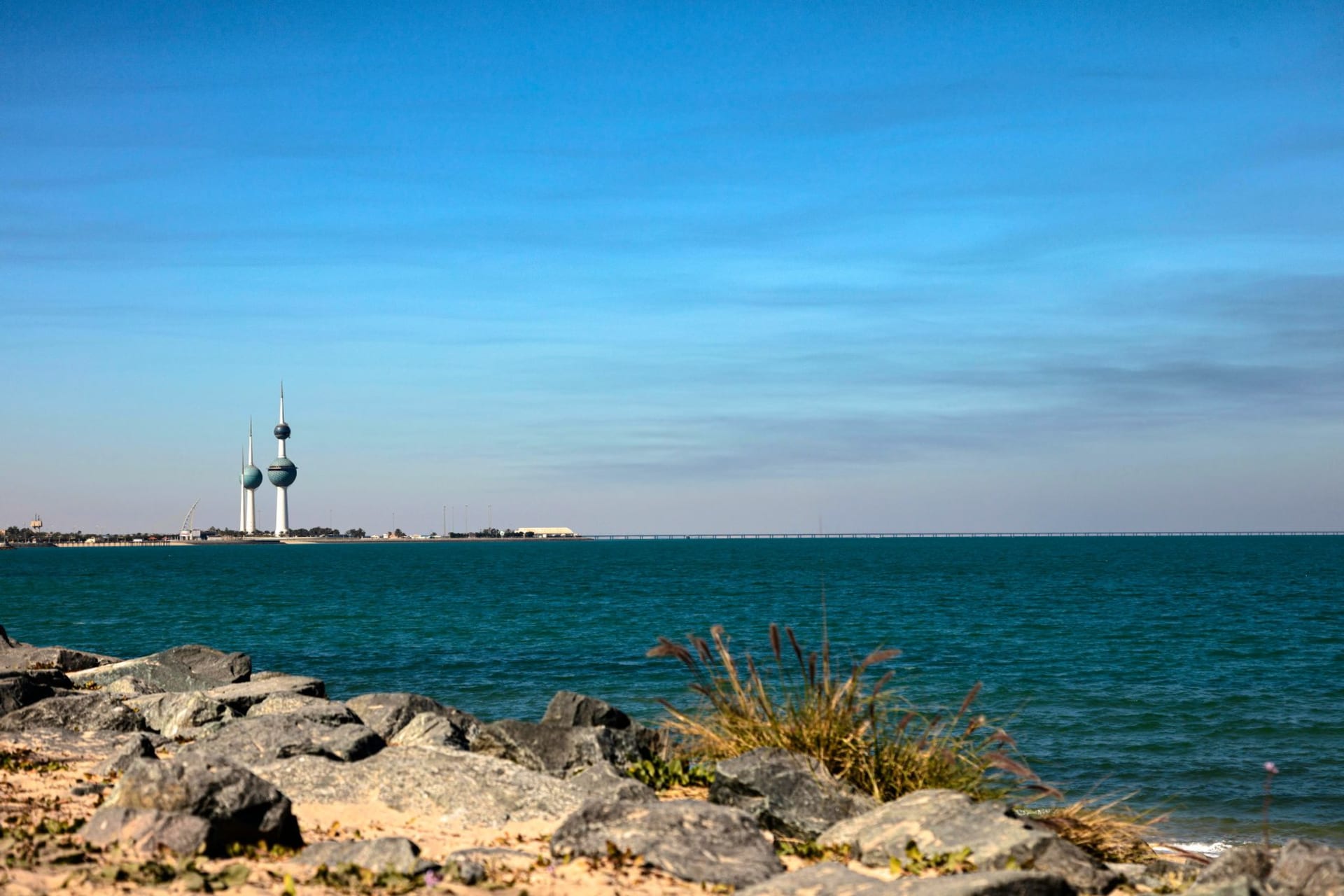 The Kuwait Towers rising against a bright blue sky above the waterfront Gulf shore