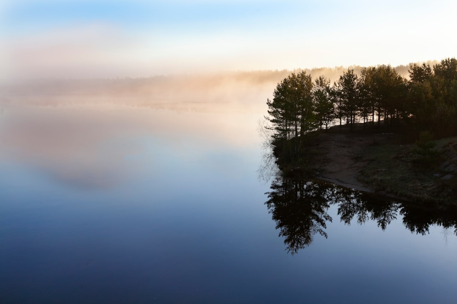Mist rising off Lake Kinrin at dawn with Mount Yufu in the background