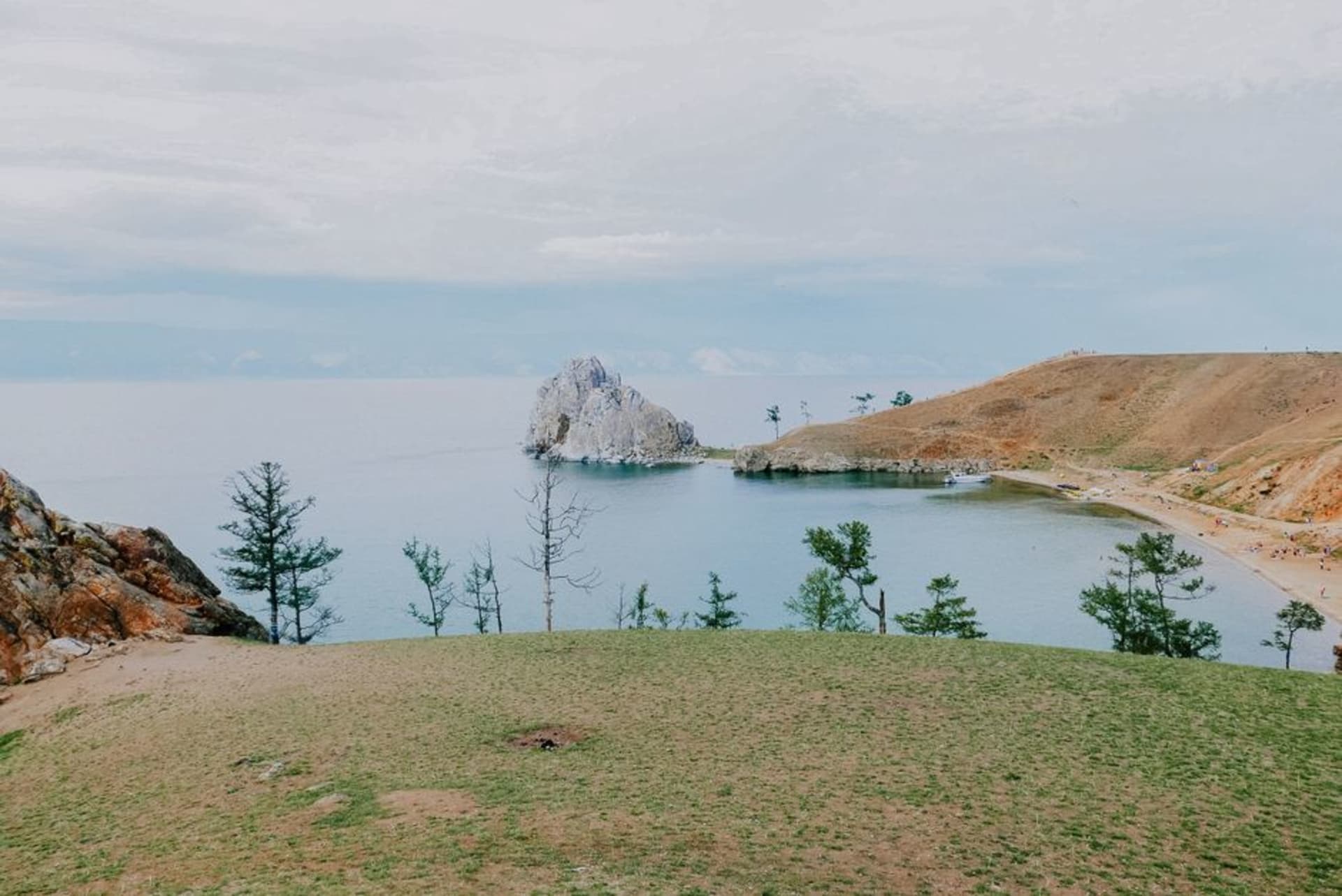 Chivyrkuisky Bay at golden hour with the Svyatoy Nos peninsula rising behind calm water