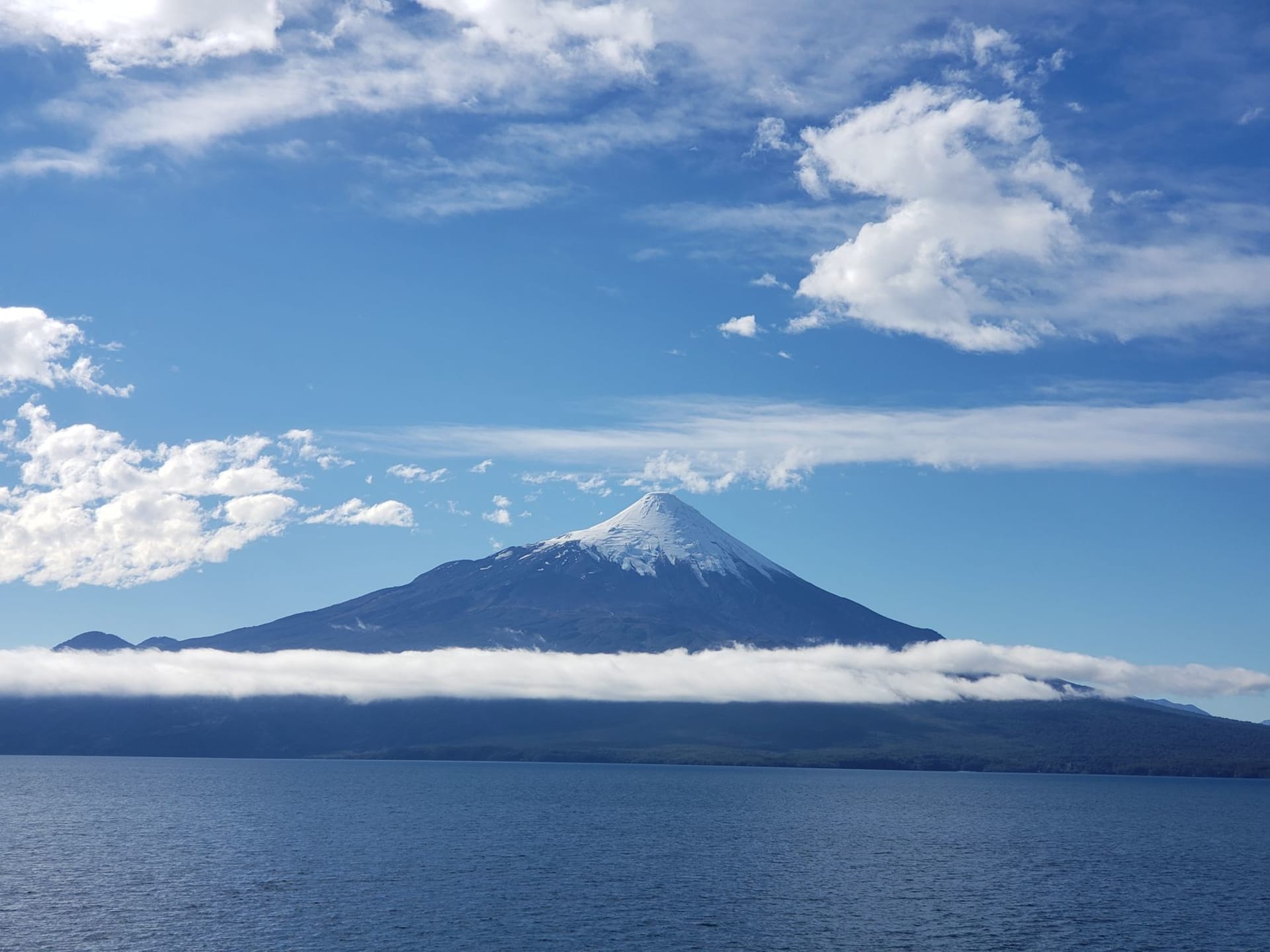 Osorno Volcano rising above Puerto Varas with its near-perfect snow cone reflected in the clear sky