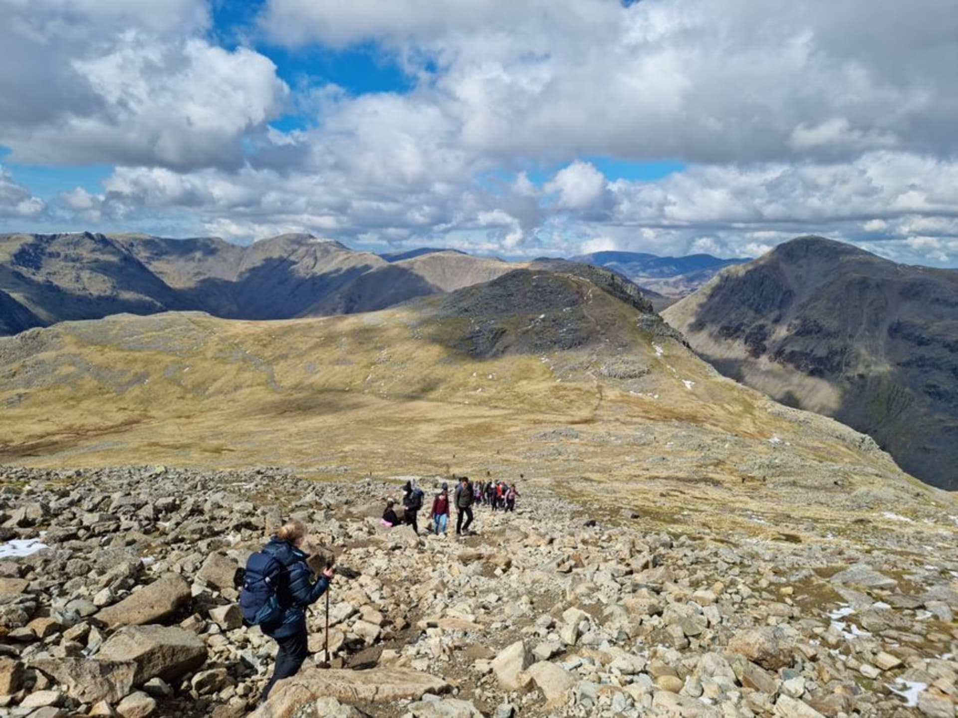 The rocky summit plateau of Scafell Pike with cairn and panoramic views over the Lakeland fells