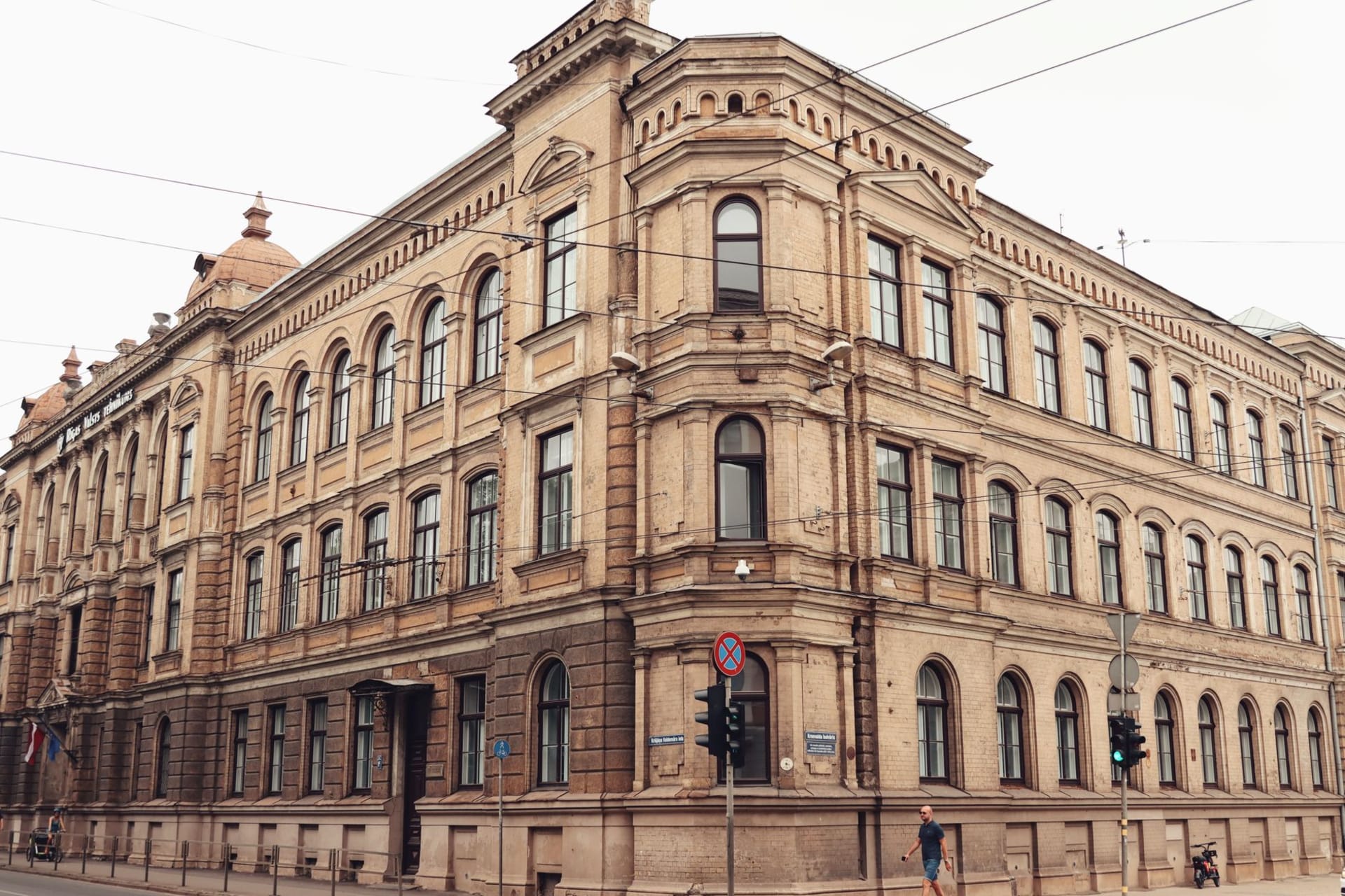 Riga's Blackheads' House with its ornate Dutch Renaissance facade reflected in rain-slicked cobblestones at dusk