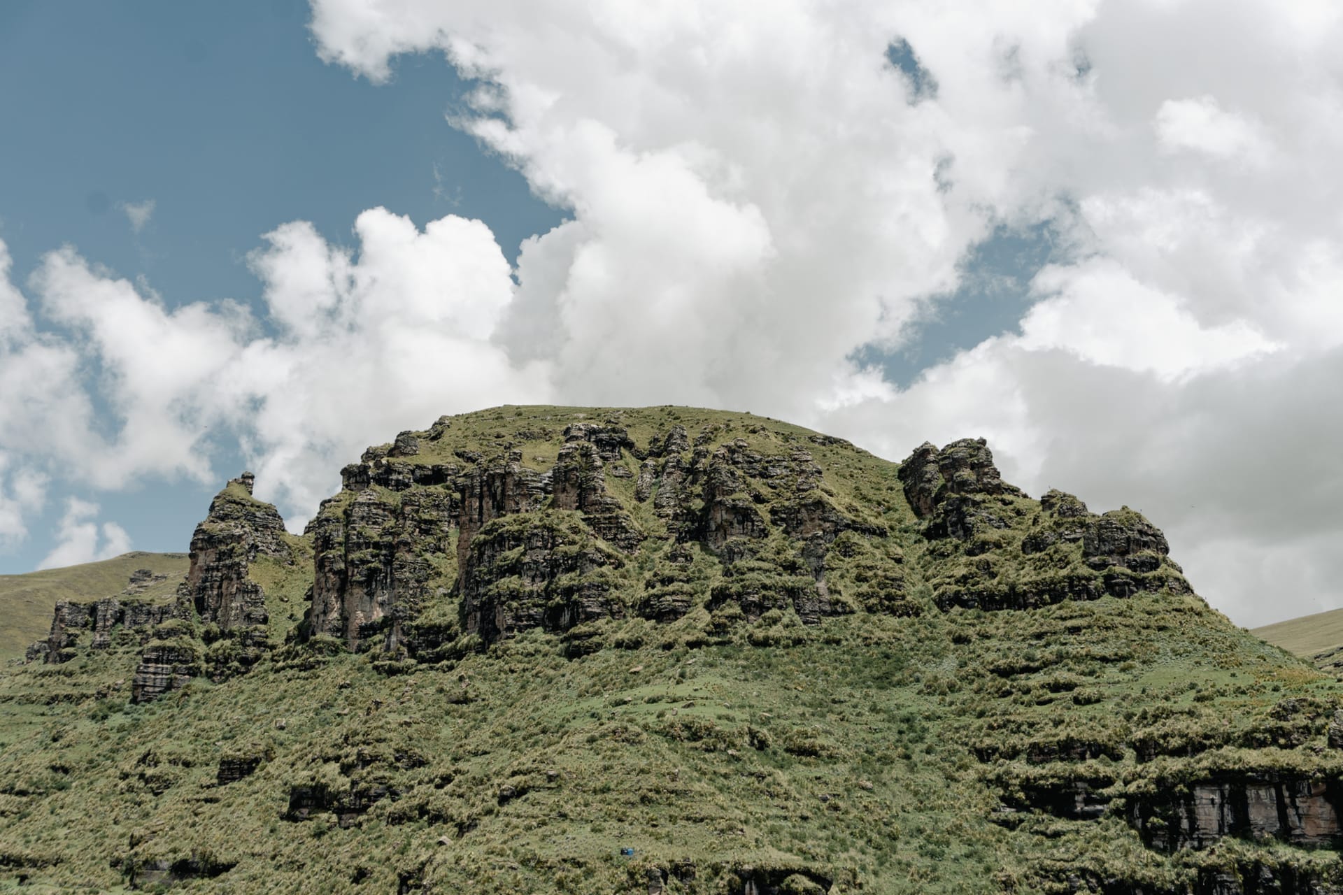 The Bokong plateau in Lesotho under a vast sky, brown alpine grassland falling away toward distant Maluti peaks