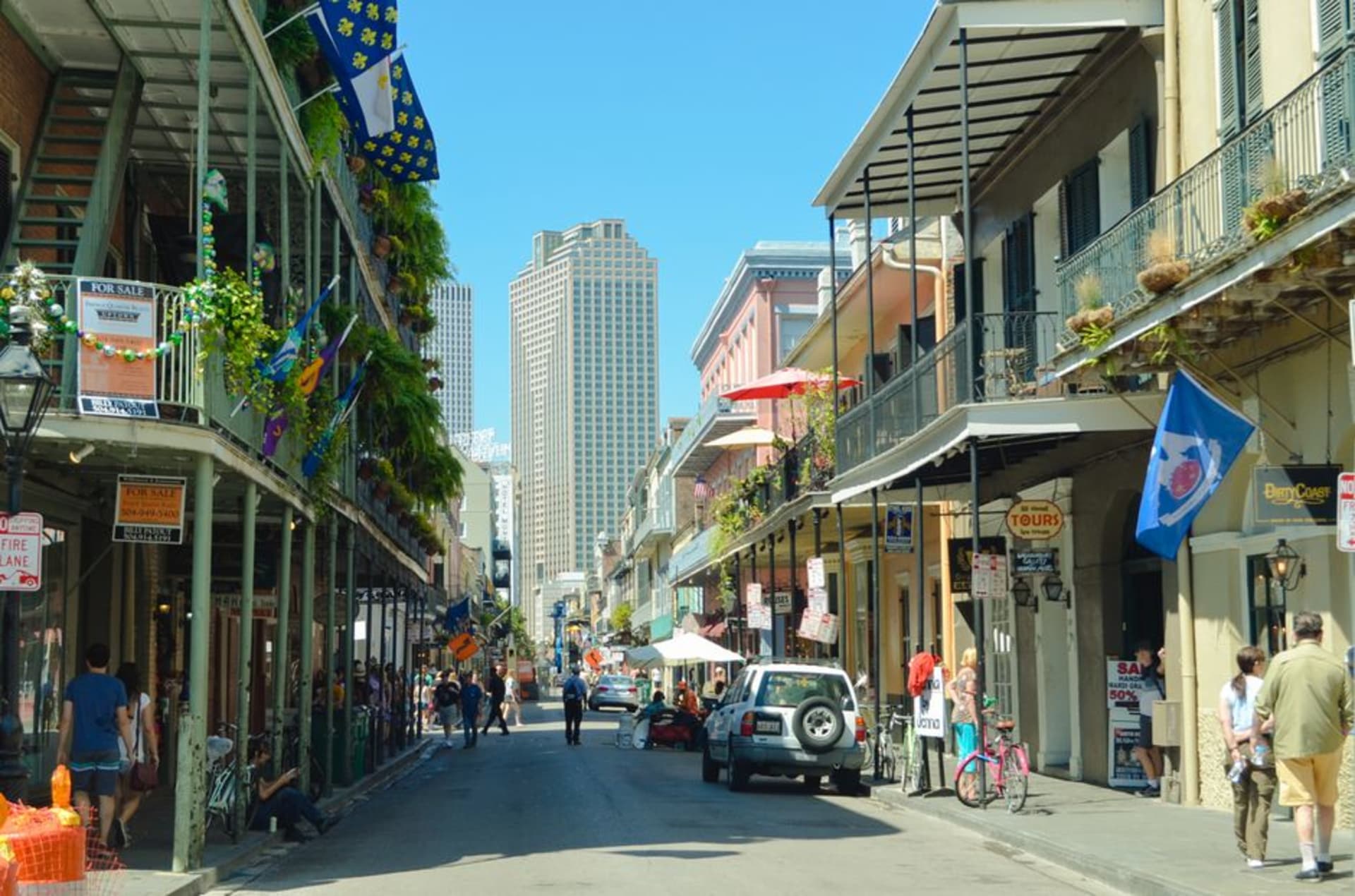 The historic main street of St. Francisville lined with old brick and timber storefronts under oak trees