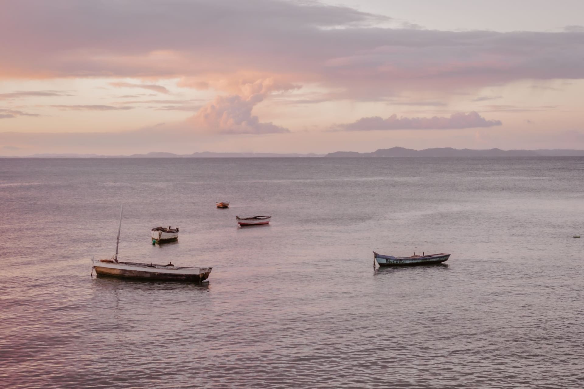 St Peter's Cathedral on Likoma Island rising above mango trees and the blue waters of Lake Malawi at sunset