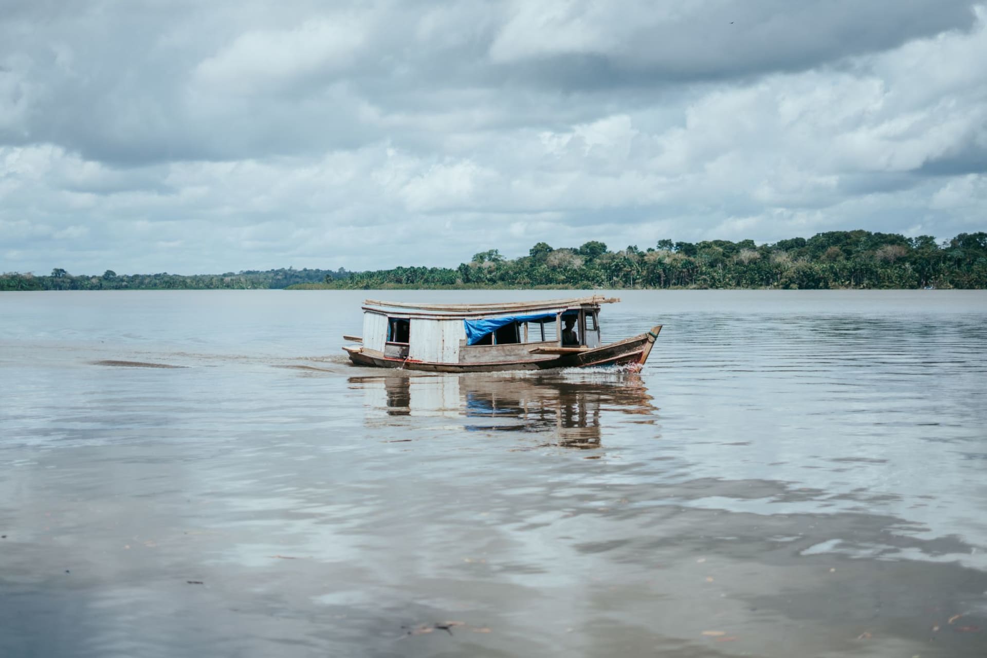 Stone ruins of a colonial Jesuit church rising from a palm-fringed beach at Joanes, MarajÃ³ Island, with storm clouds gathering offshore