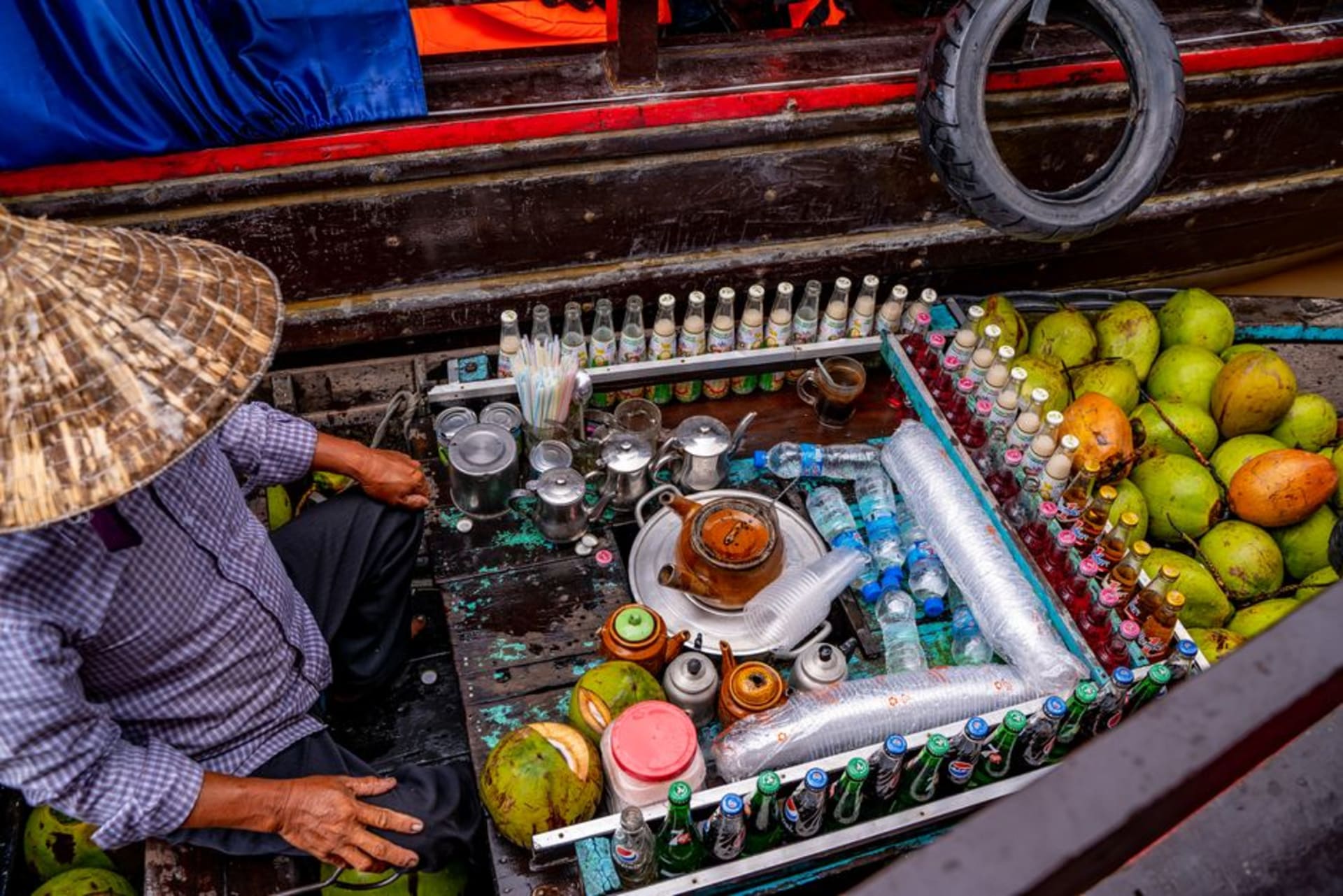 Wooden vendor boats piled with produce on the Tien Giang branch of the Mekong River at Cai Be