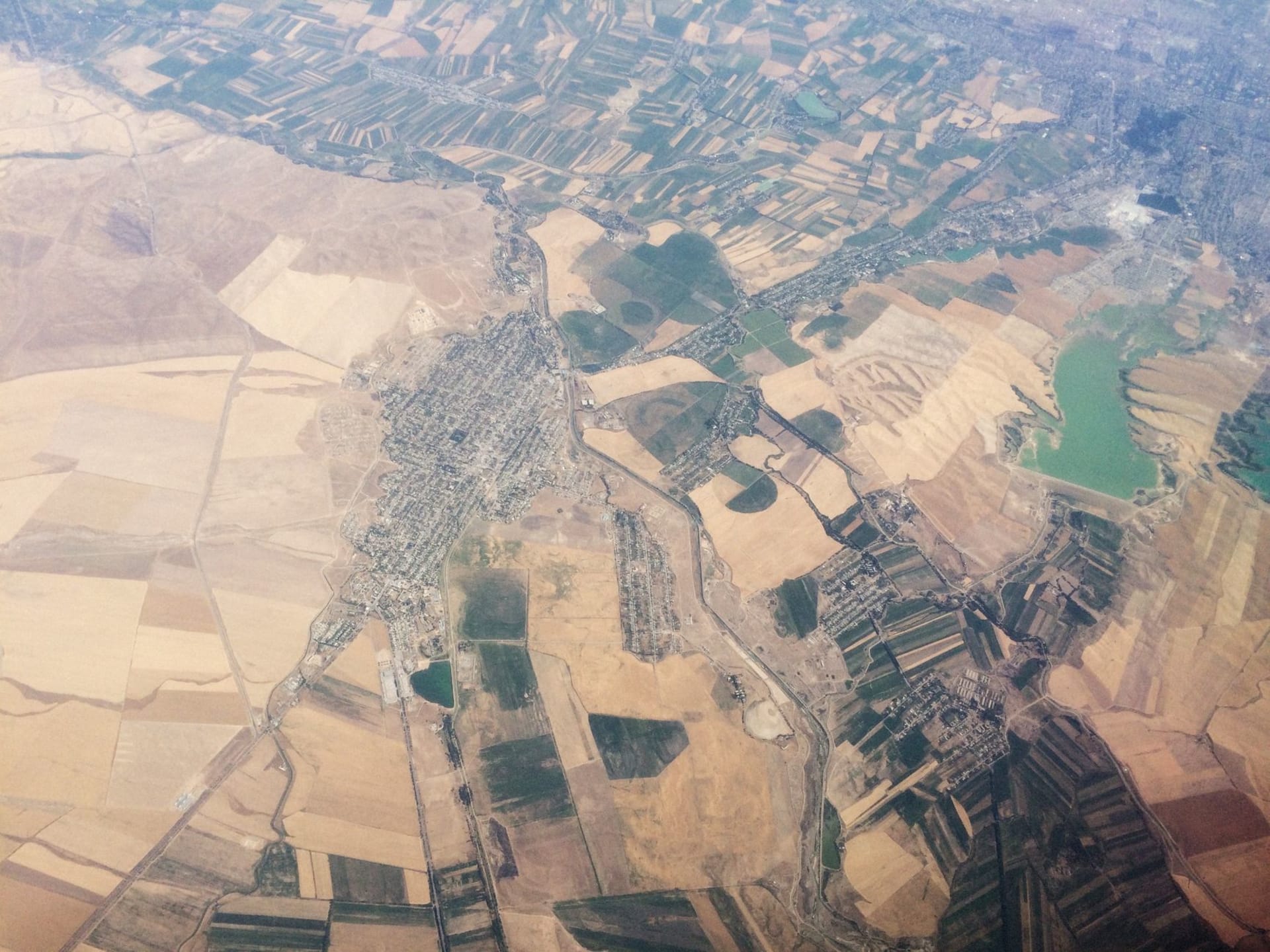 The ancient mud-brick Citadel of Erbil rising above the modern city on its massive tell, the oval mound climbing 30 meters above the surrounding bazaar and streets below