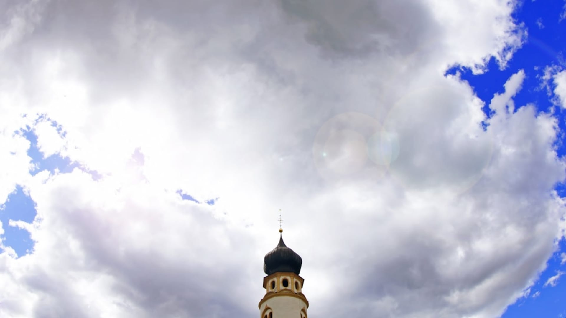 The spiral cone-shaped minaret of the Great Mosque of Samarra, the Malwiya, rising from a flat brick base against a clear sky, its exterior ramp visible winding upward
