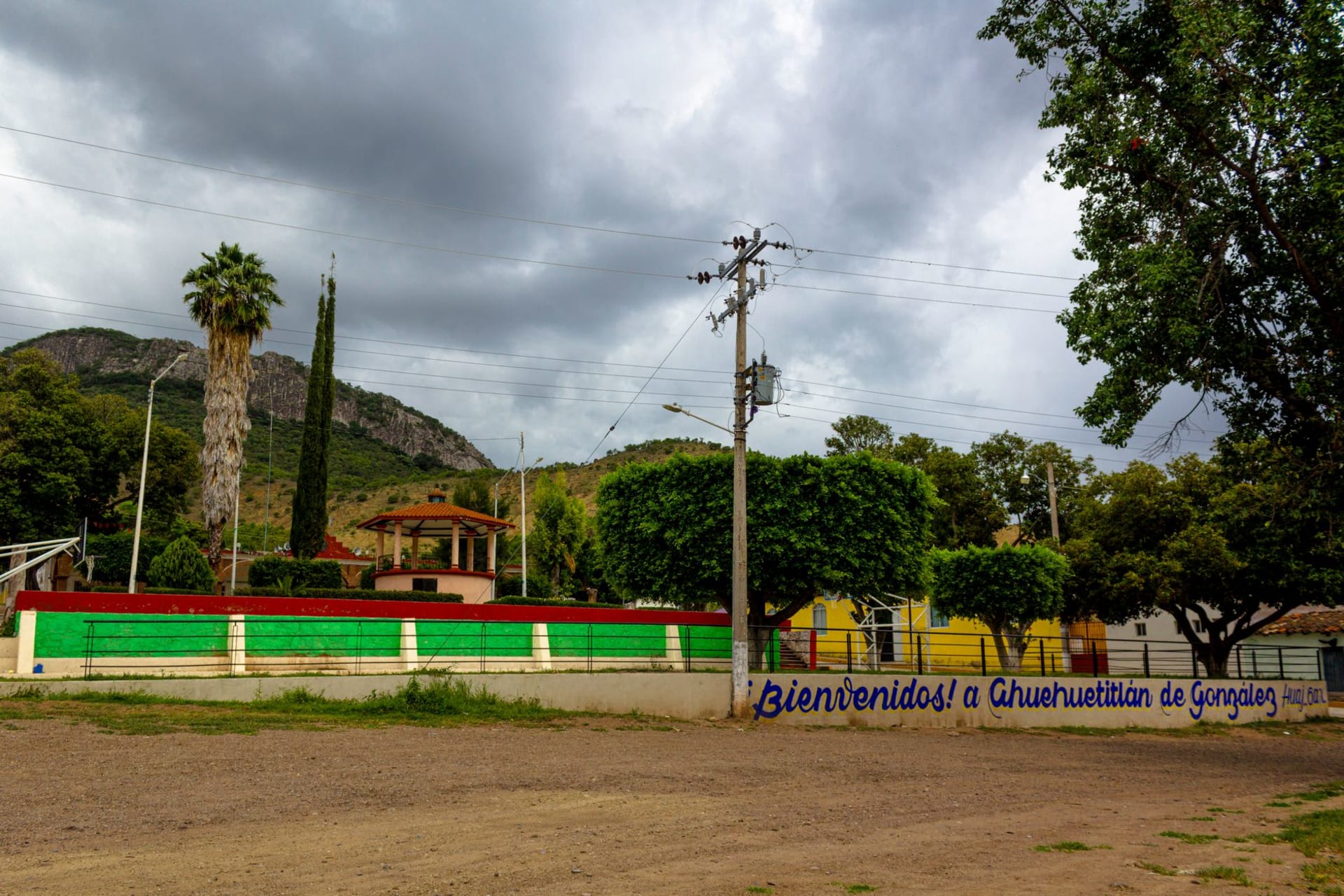 Avocado orchards on the hillsides above the Apatzingán valley, Tierra Caliente landscape stretching to the horizon in afternoon heat haze