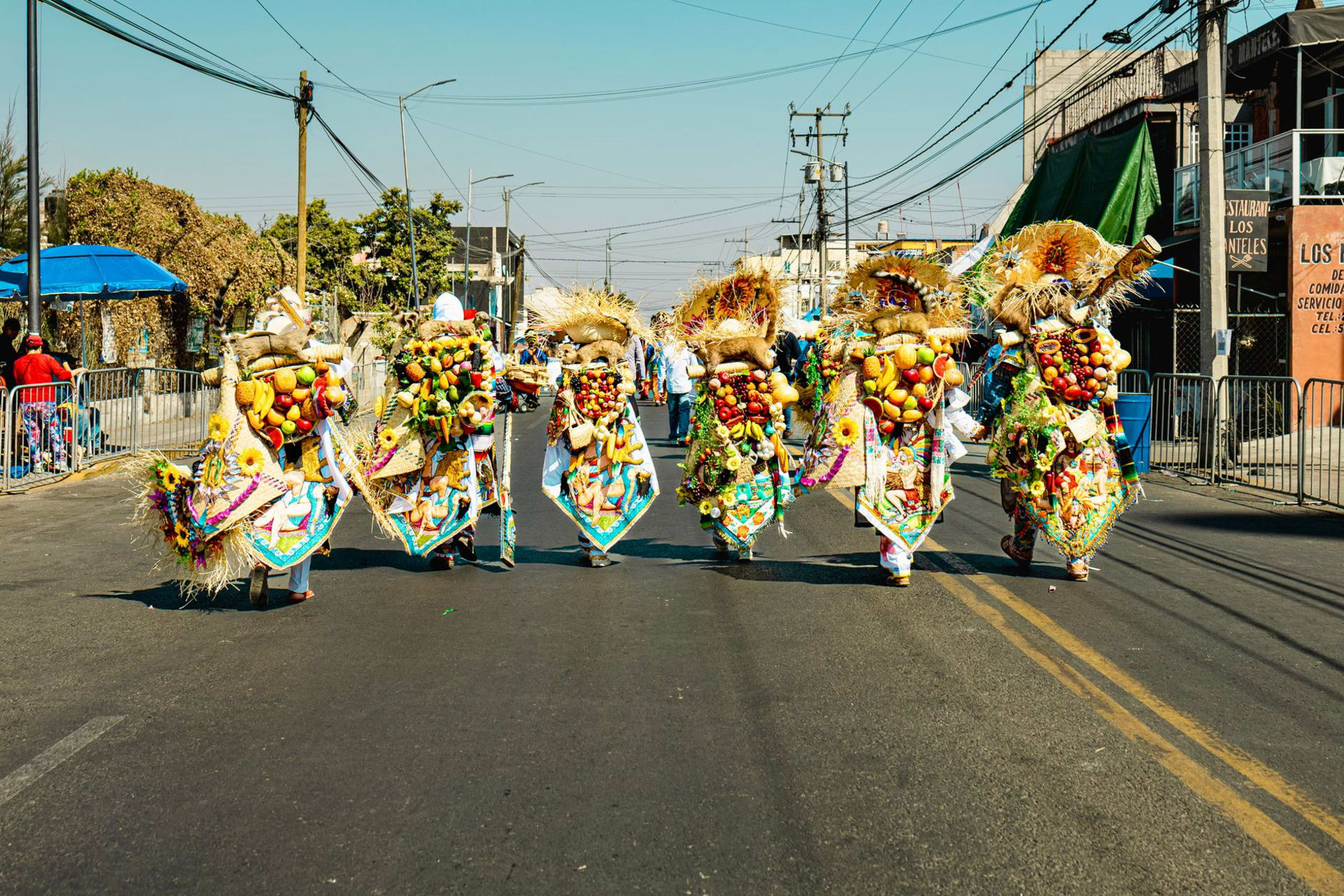 The main battle mural at Cacaxtla under its protective roof structure, vivid blue and red figures of warriors in jaguar and bird costumes on the painted wall