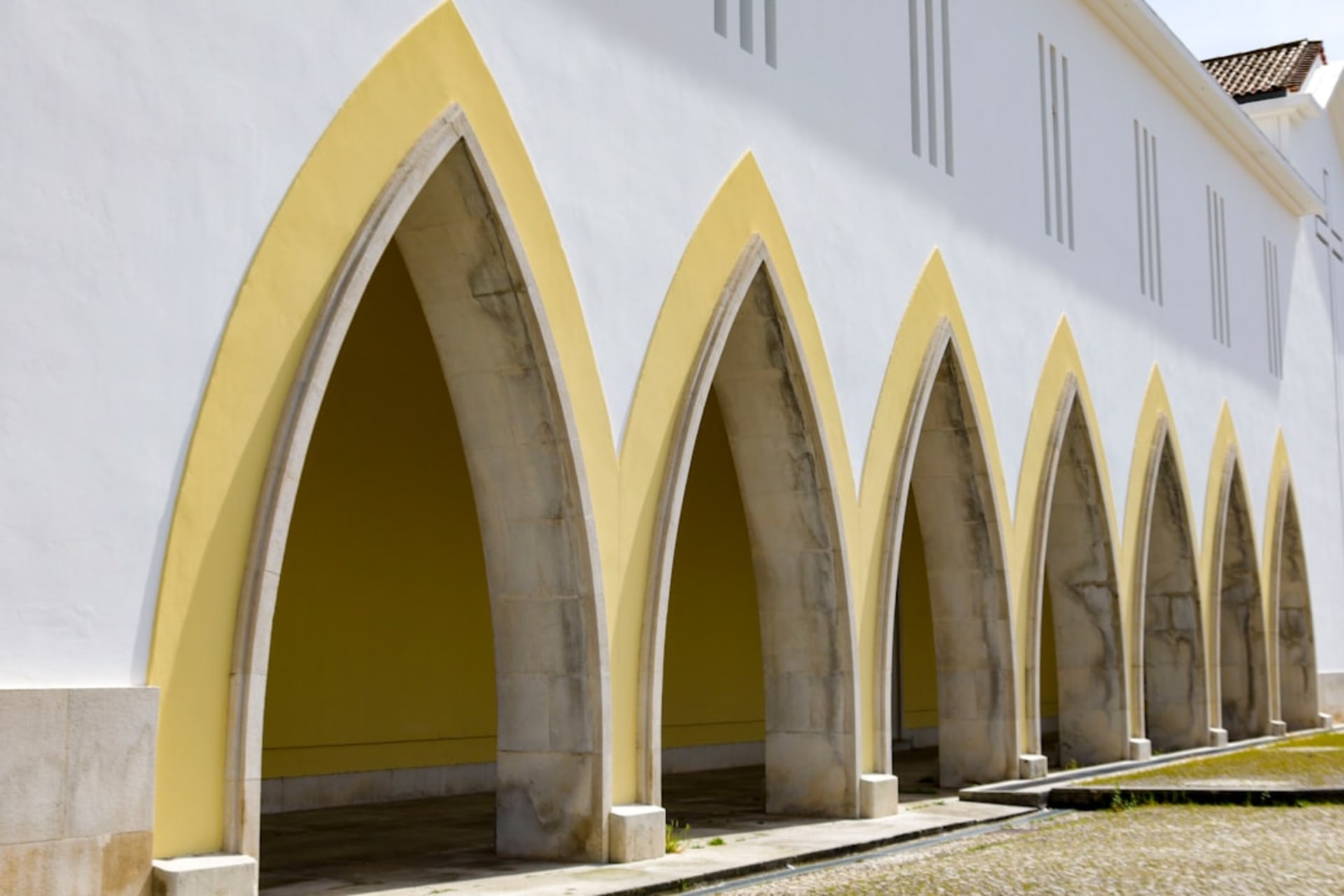 The mustard-yellow facade of the Convento de San Luis Obispo glowing in late afternoon light, Calkiní, Campeche
