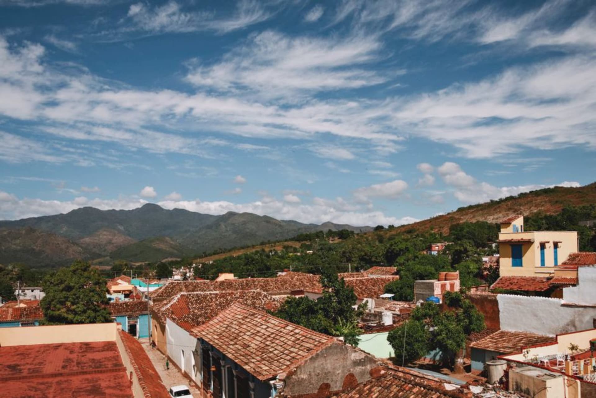 Stone-paved street in Cosalá with colonial facades and the sierra rising behind the town