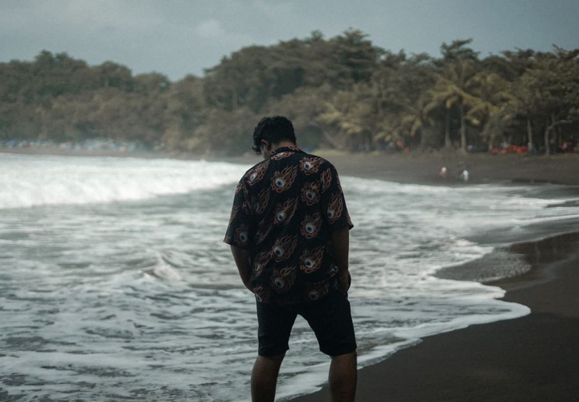 Black volcanic sand stretching along the Pacific shore at golden hour in Cuyutlán, Colima