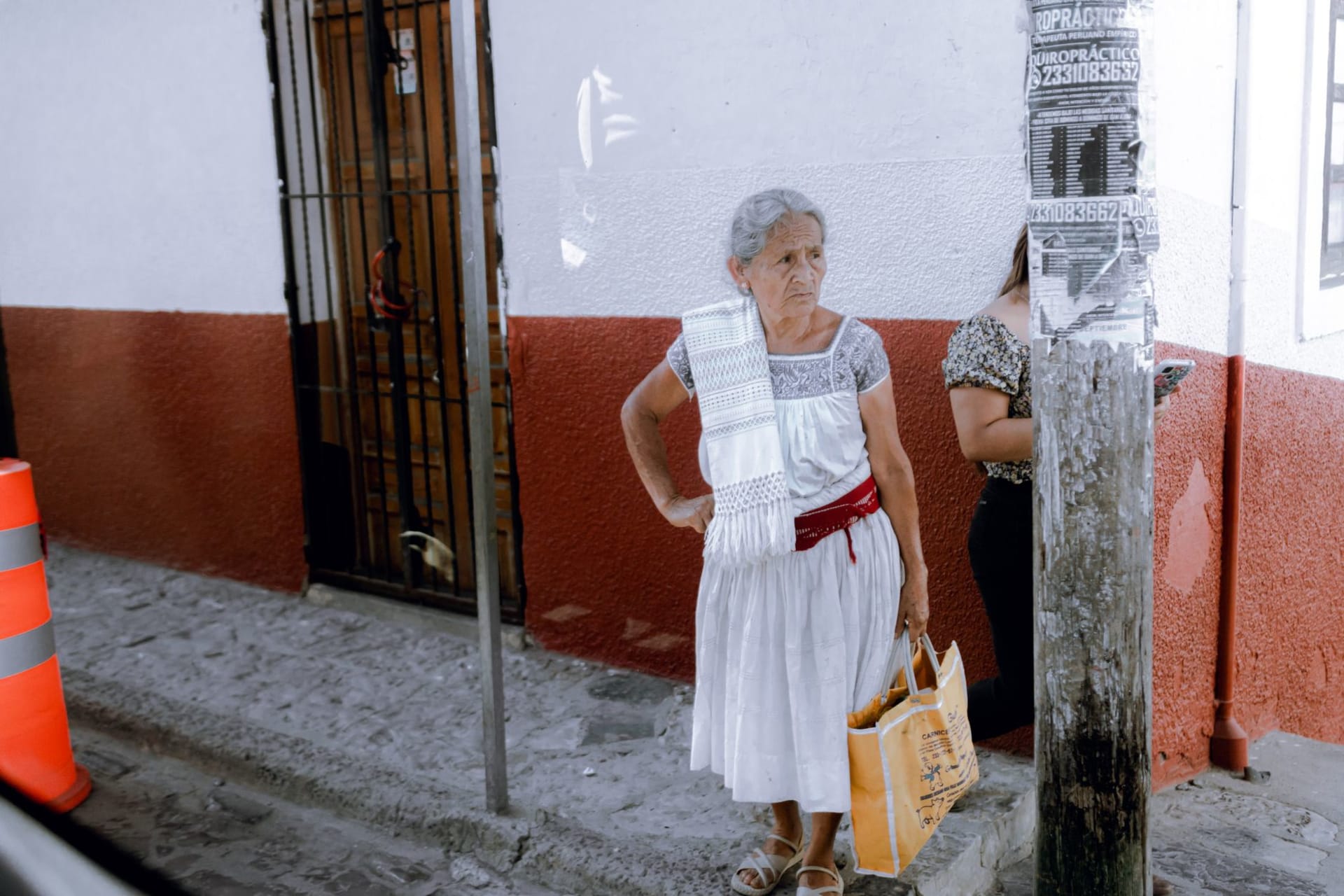 A three-story Huaquechula ofrenda filling an entire room, covered in marigolds, candles, and photographs of the deceased surrounded by food offerings and personal objects
