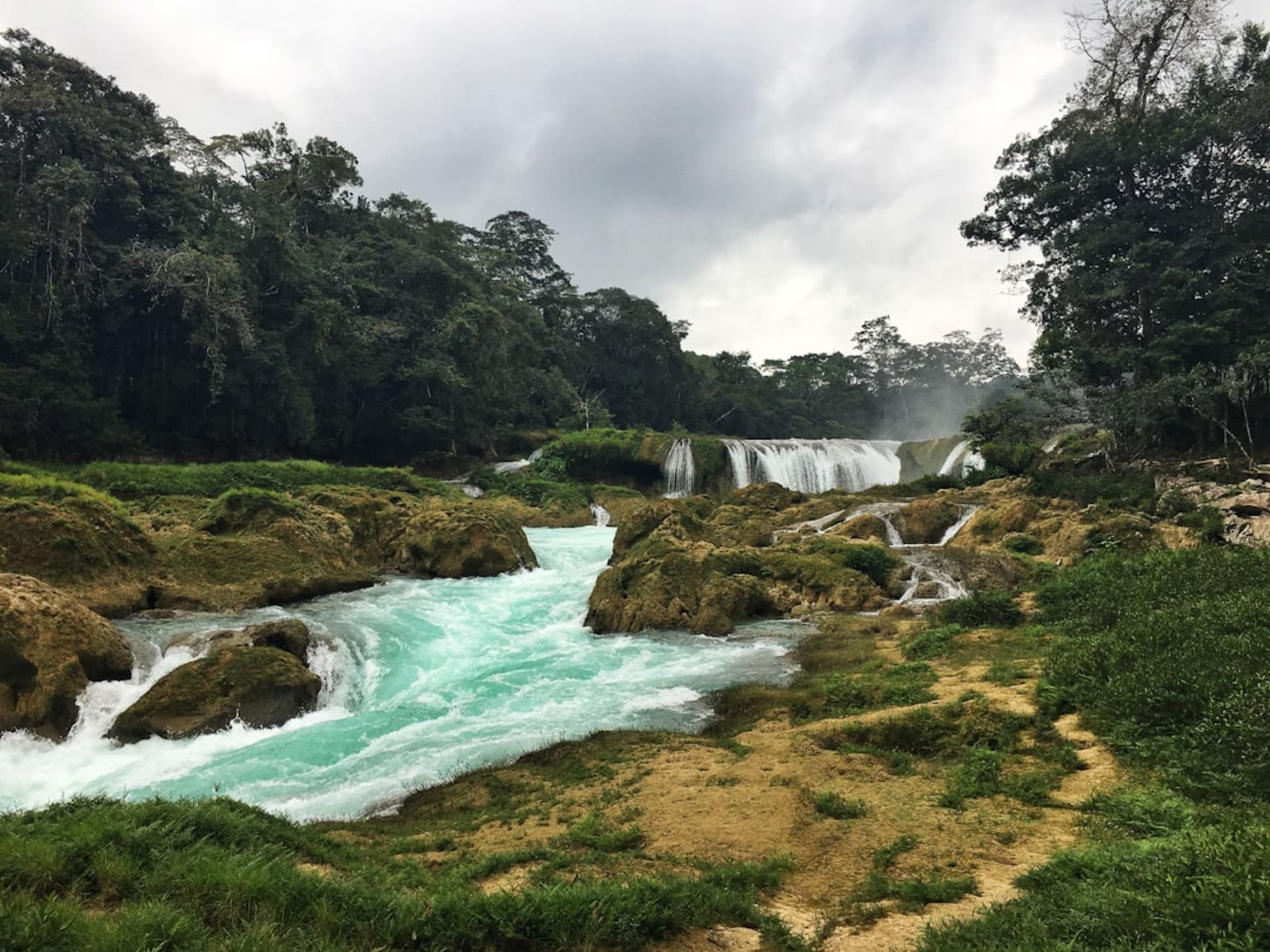 Turquoise-green rapids cascading through layered limestone rock formations at Las Nubes on the Jatate River, Lacandon jungle, Chiapas