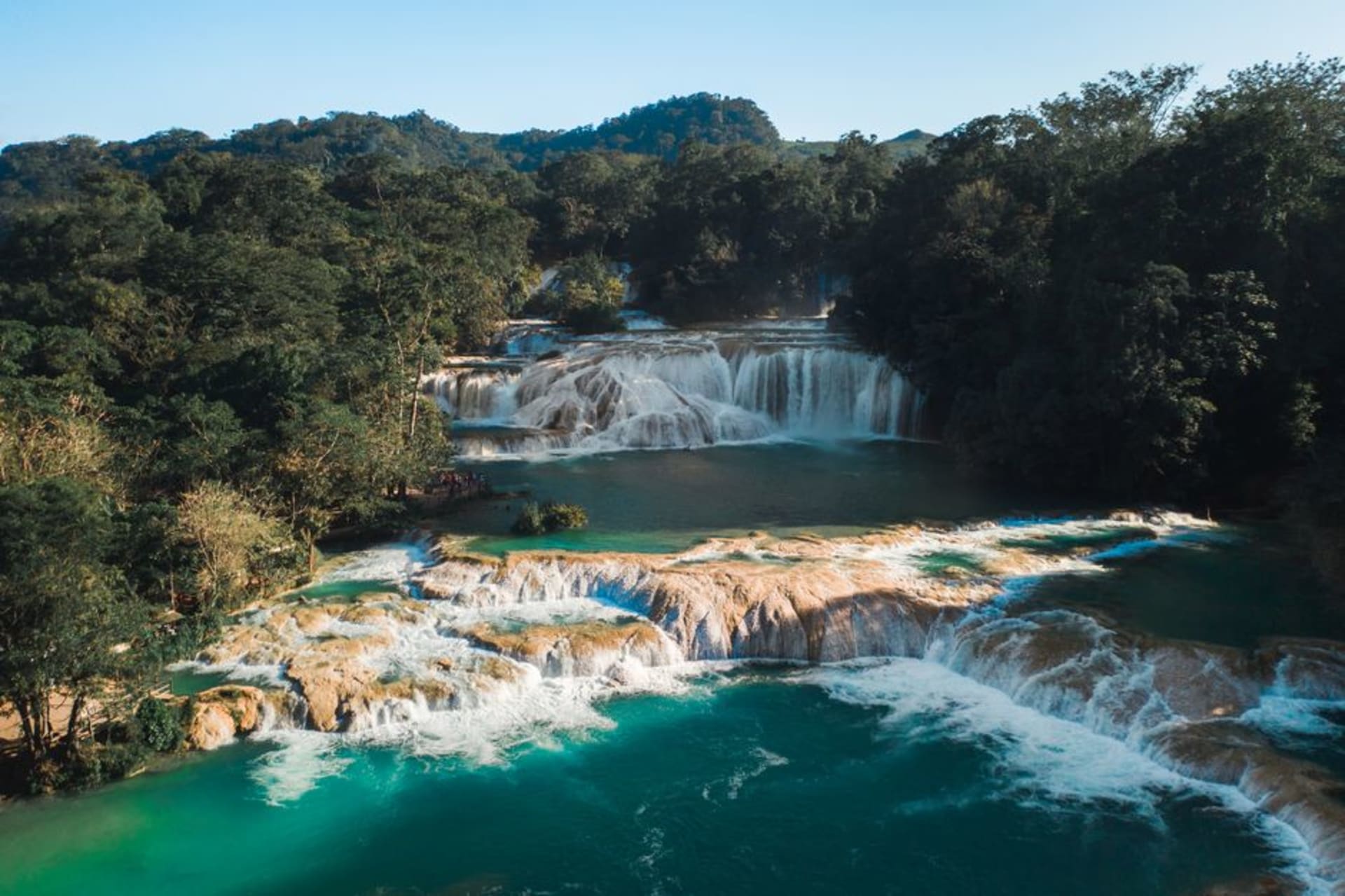 The Misol-Ha waterfall dropping 35 meters into a jungle pool surrounded by dense Chiapas rainforest