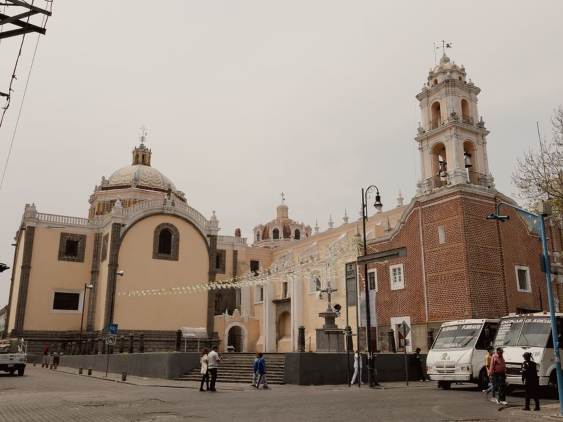 The stone facade of the Parroquia de Nuestra Señora de la Asunción catching early morning light across an empty atrium in Sinaloa de Leyva