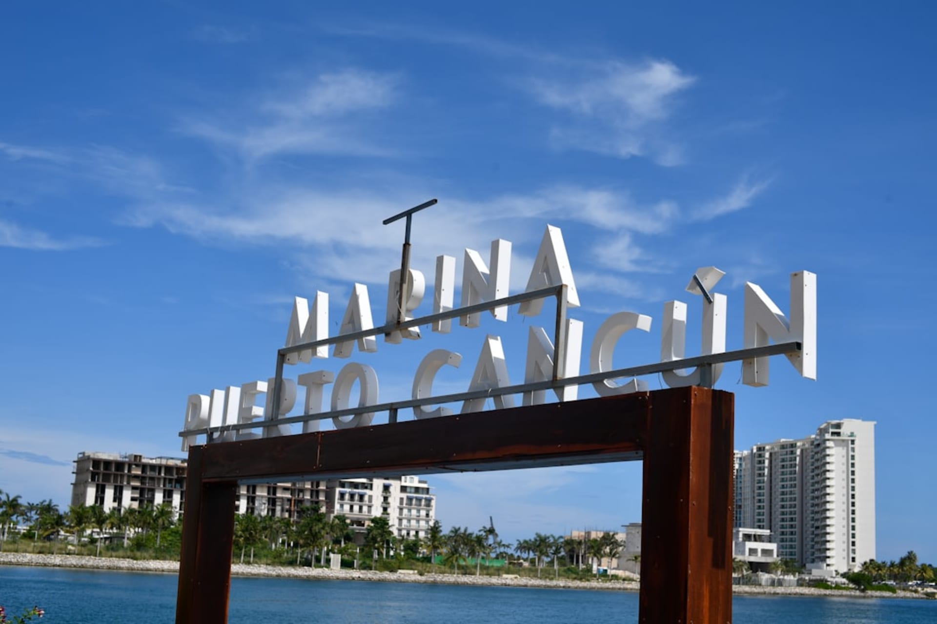 The old port of Sisal in Yucatán, the 19th-century customs house on the waterfront, the fishing boats on the beach, the Gulf of Mexico beyond, the flat Yucatán coastline stretching in both directions