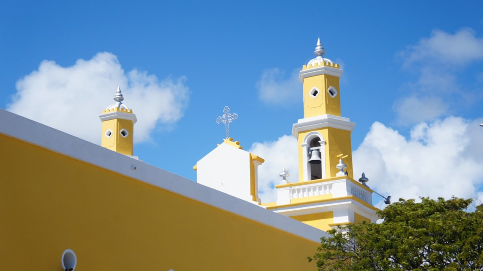 The baroque facade of the Convento de los Tres Reyes Magos rising above the main square of Tizimín at golden hour