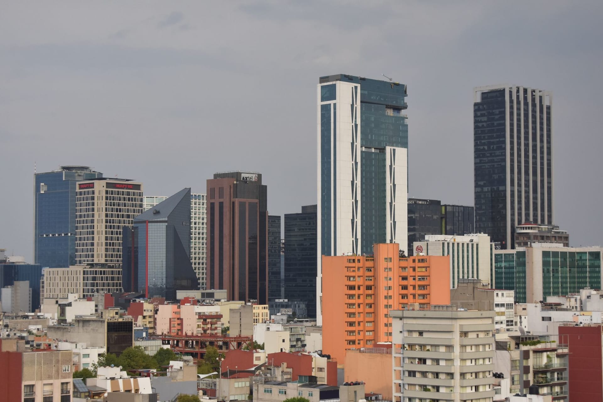 The Plaza de las Tres Culturas in Tlatelolco, the Aztec pyramid ruins in the foreground, the colonial church of Santiago behind, and the modernist SRE building closing the far end