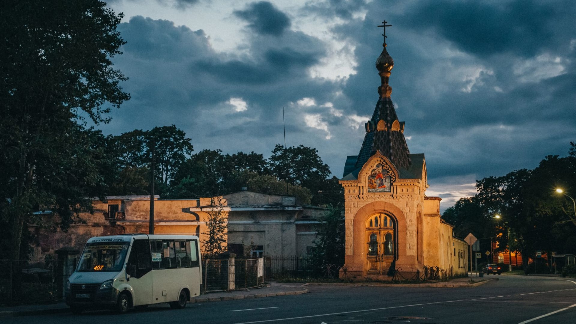 Long underground tunnel in Cricova wine cellars lit by warm golden light, rows of wine bottles stacked in arched limestone niches on both sides