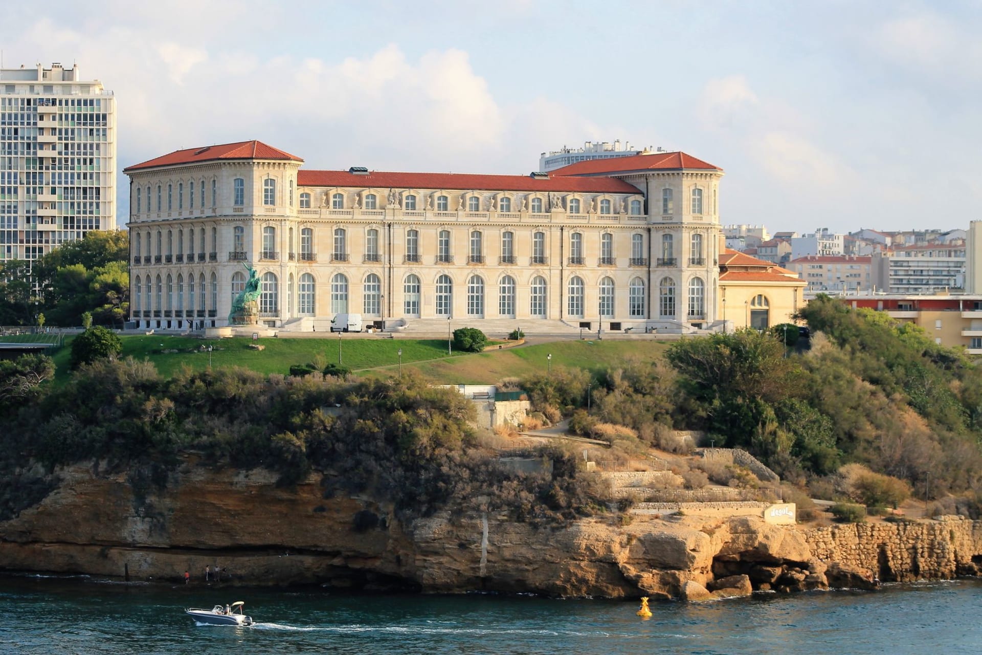 The Musée Océanographique rising from the cliff edge of Monaco-Ville, its stone facade overhanging the deep blue Mediterranean far below