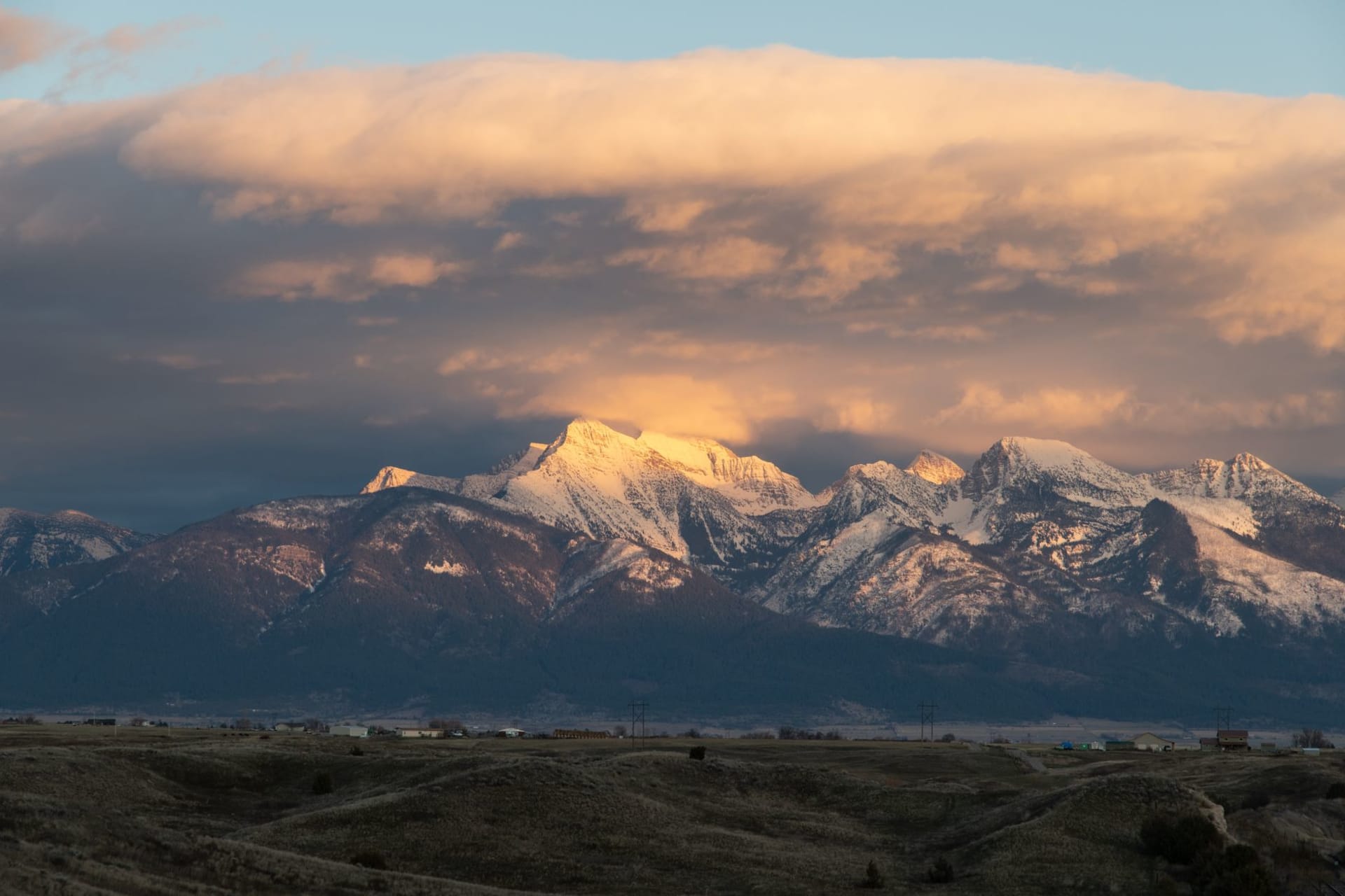 The eastern front of the Rocky Mountains rising abruptly from the open plains near Browning, Montana on a dramatic cloudy day