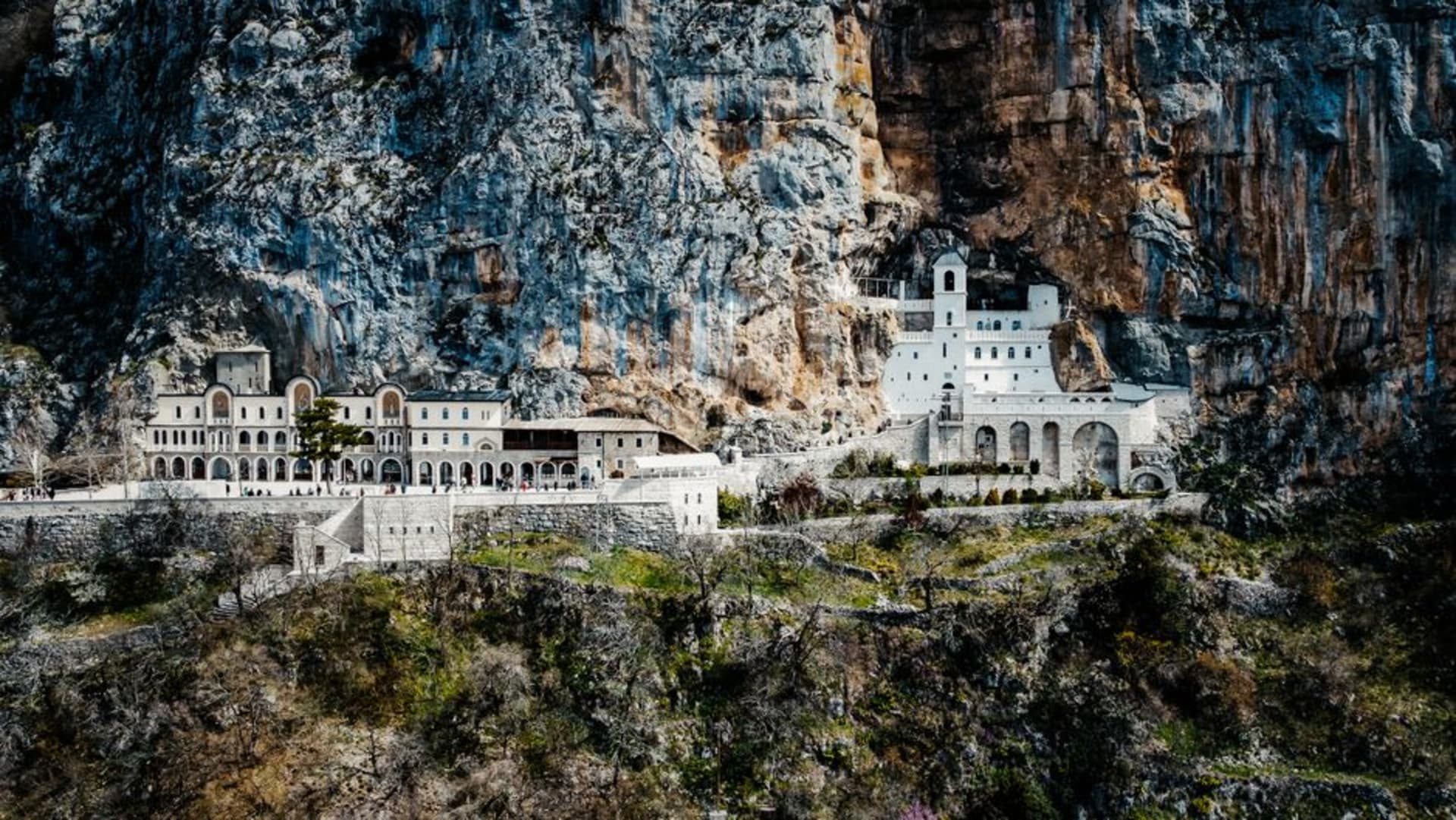 Ostrog Monastery built into the vertical cliff face above the Bjelopavlići plain in Montenegro