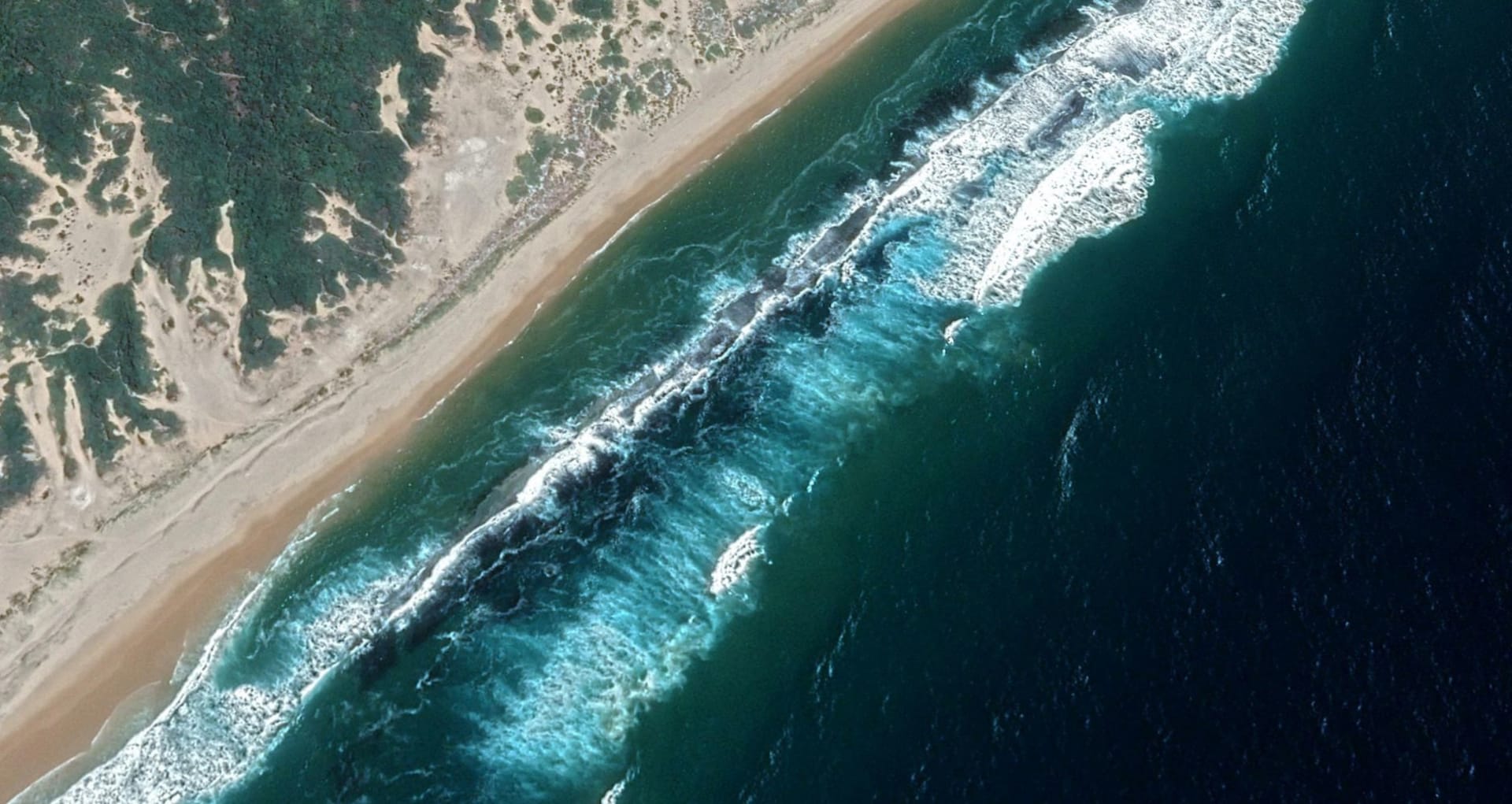 Aerial view of the Mozambique coastline with clear turquoise waters and white sandy beaches