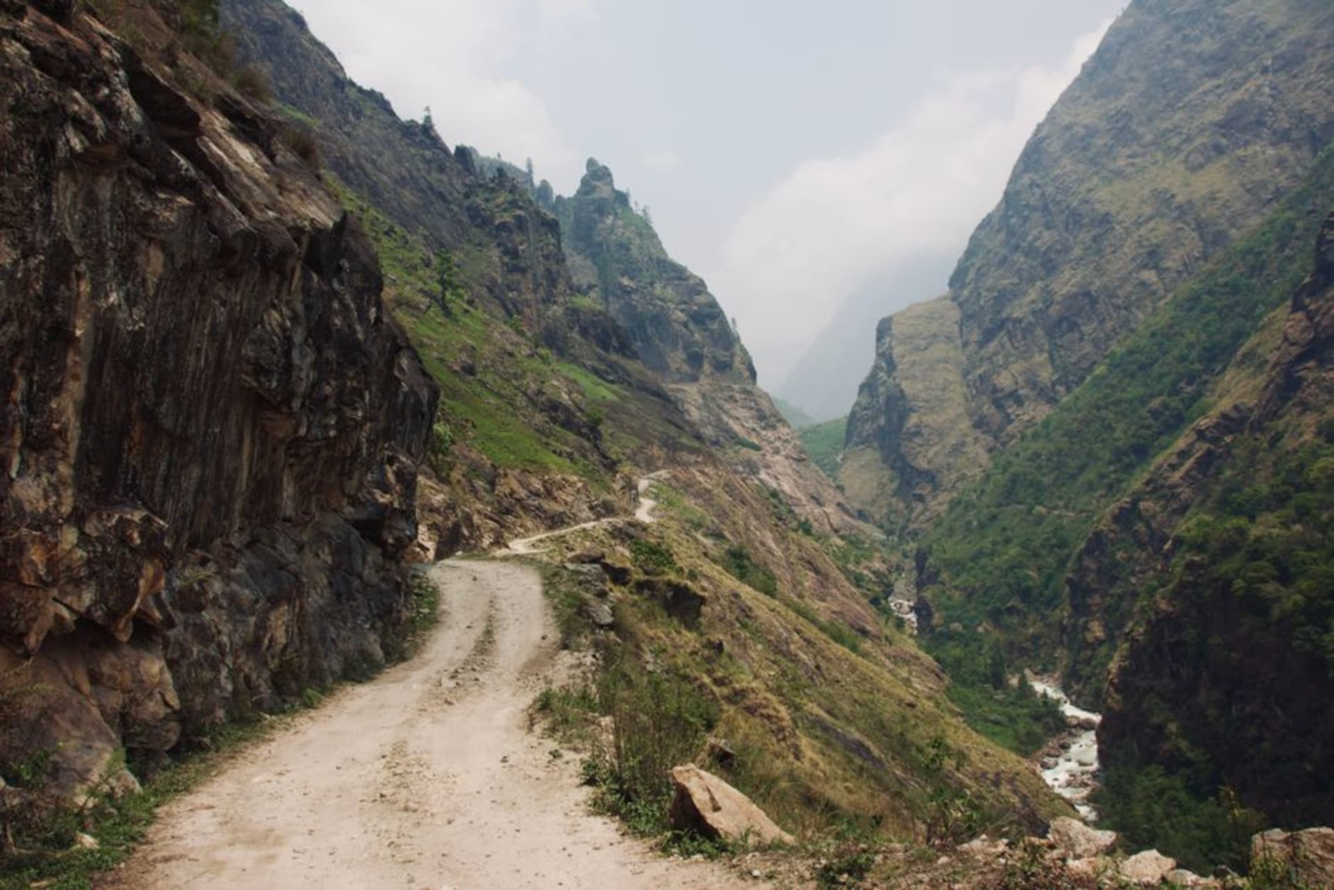 Deep, narrow gorge of the milky Seti River cutting through Pokhara, viewed from the K.I. Singh Bridge above