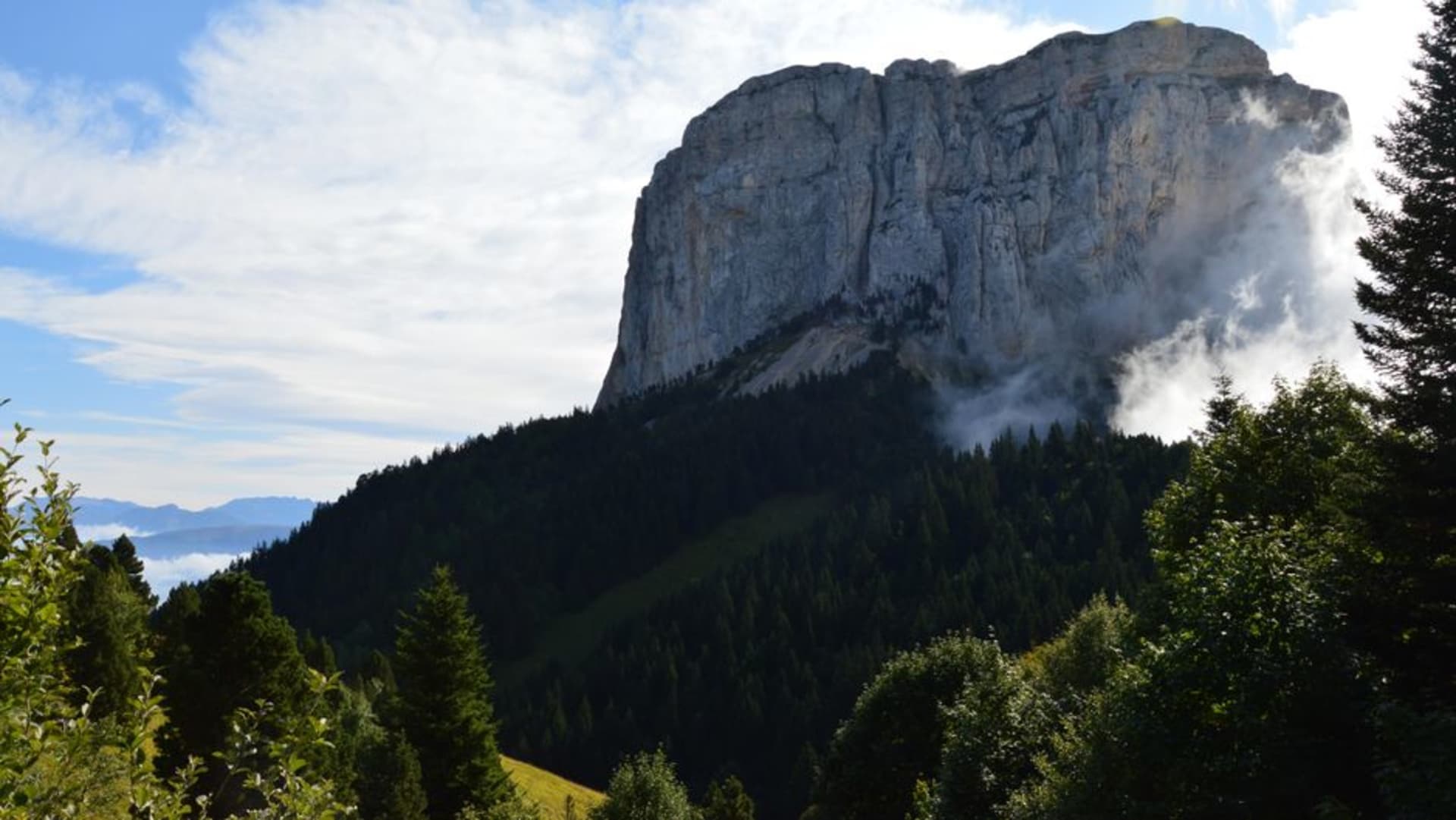 La crête sommitale enveloppée de nuages du Mont Panié s'élevant au-dessus d'une forêt tropicale dense dans le nord de la Nouvelle-Calédonie